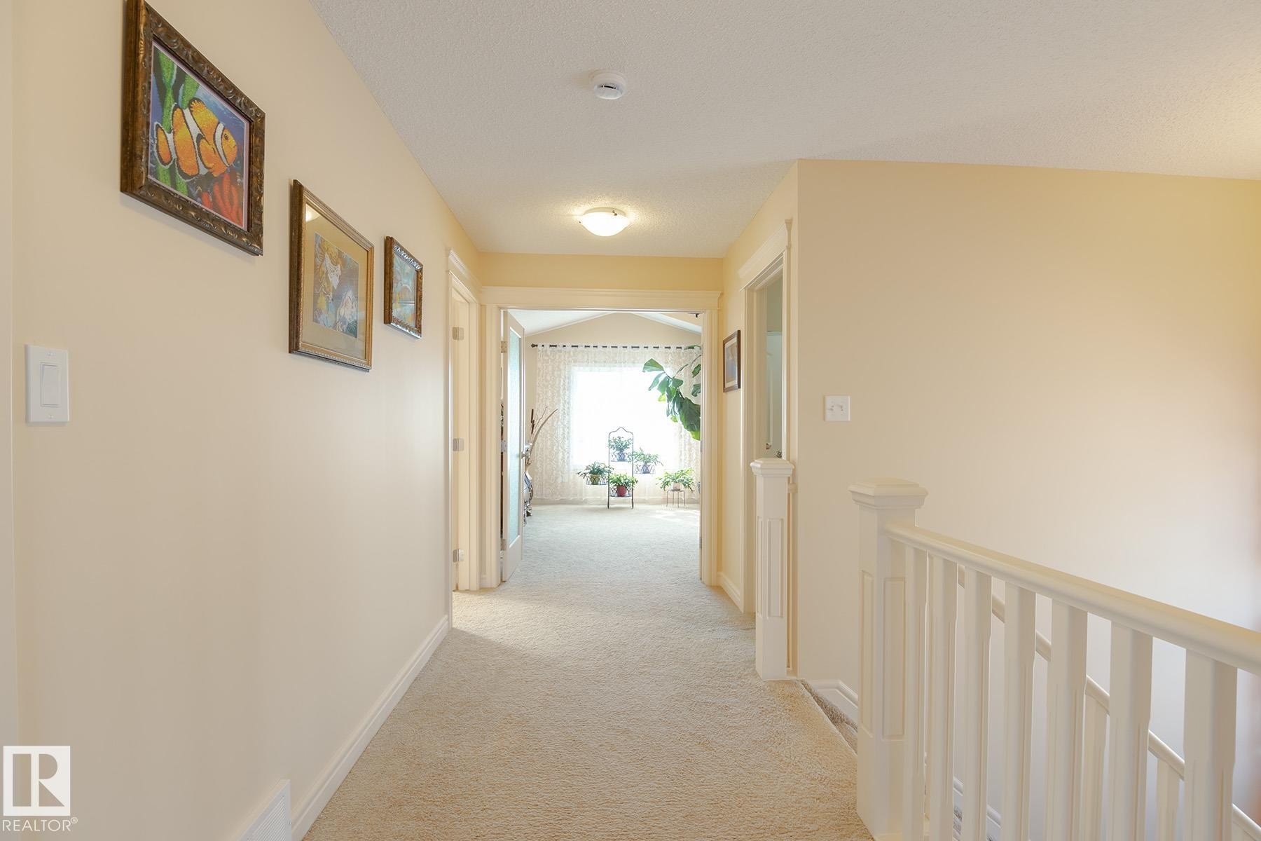 Carpeted hallway with light-toned walls and white trim - 7426 Getty Way, Edmonton, AB - Indoor Photo Showing Other Room