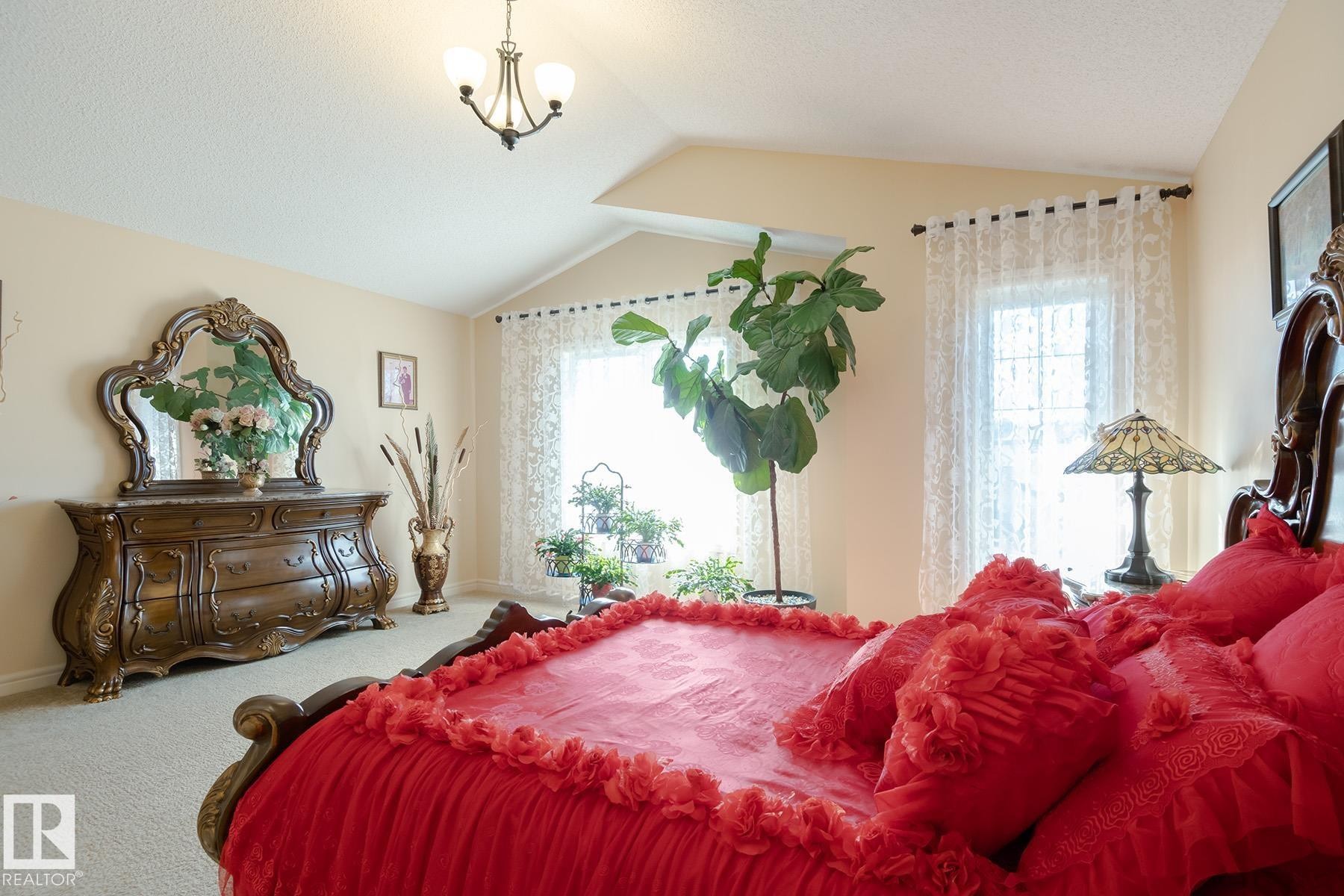 Vaulted ceiling with an overhead chandelier - 7426 Getty Way, Edmonton, AB - Indoor Photo Showing Bedroom