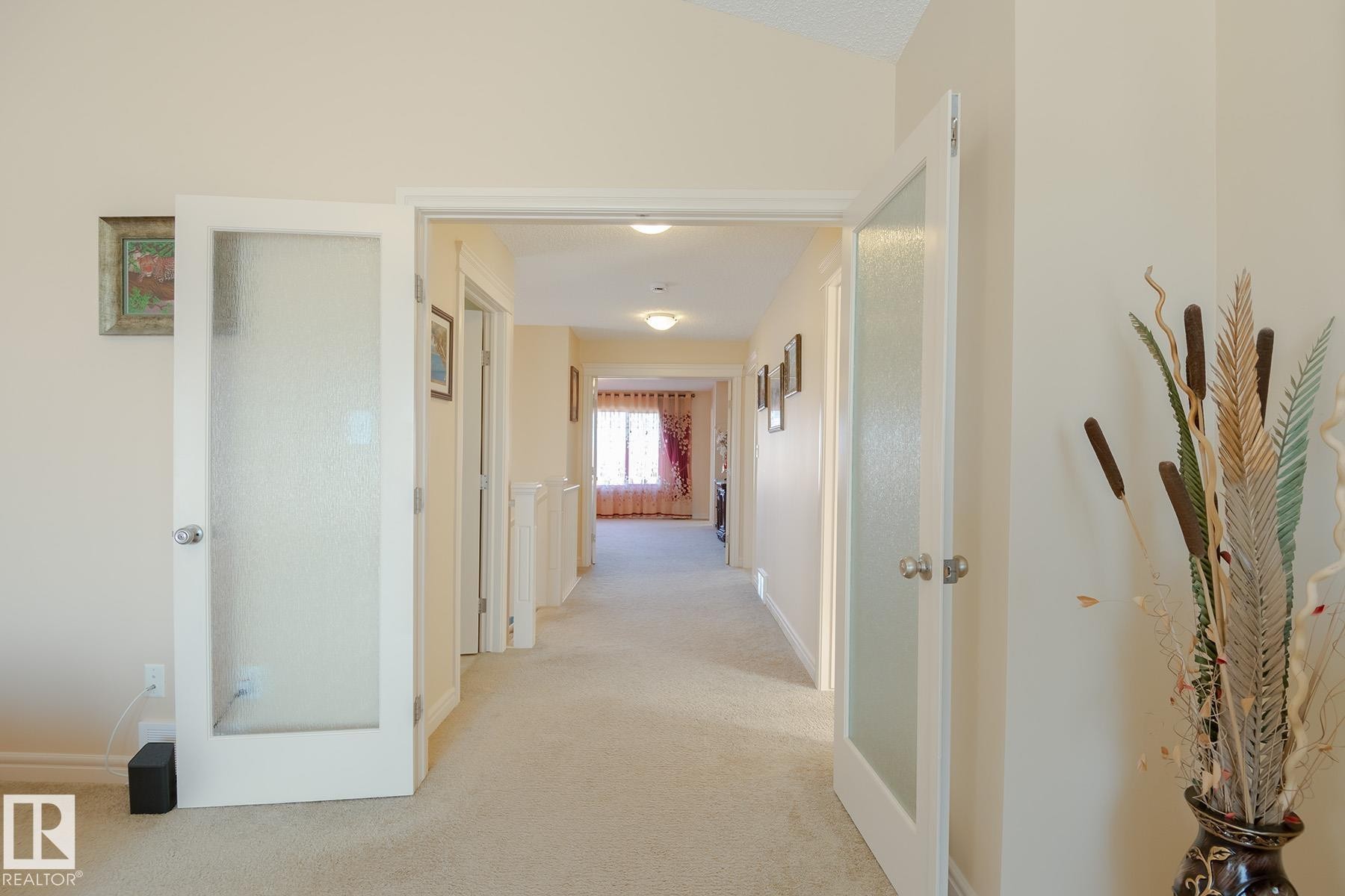 Carpeted hallway with light-colored walls and overhead lighting - 7426 Getty Way, Edmonton, AB - Indoor Photo Showing Other Room
