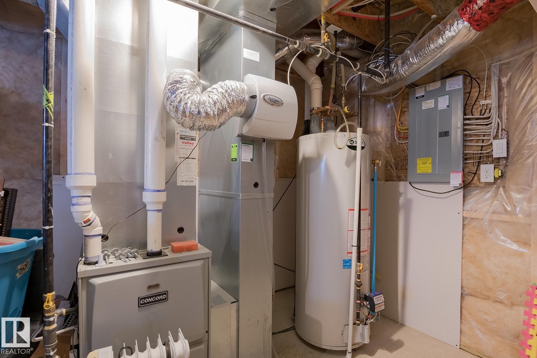 Utility area featuring a water heater, furnace, and electrical panel - 7426 Getty Way, Edmonton, AB - Indoor Photo Showing Basement