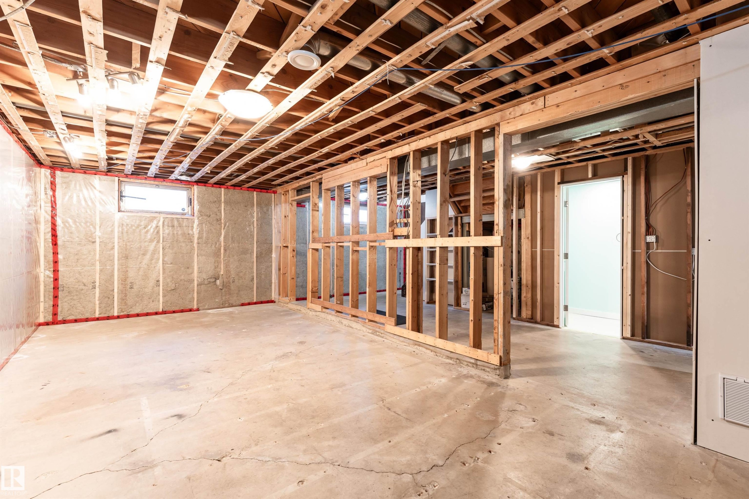 Unfinished interior space featuring exposed wood framing, concrete flooring, and ceiling joists - 13331 64 Street Nw, Edmonton, AB - Indoor Photo Showing Basement