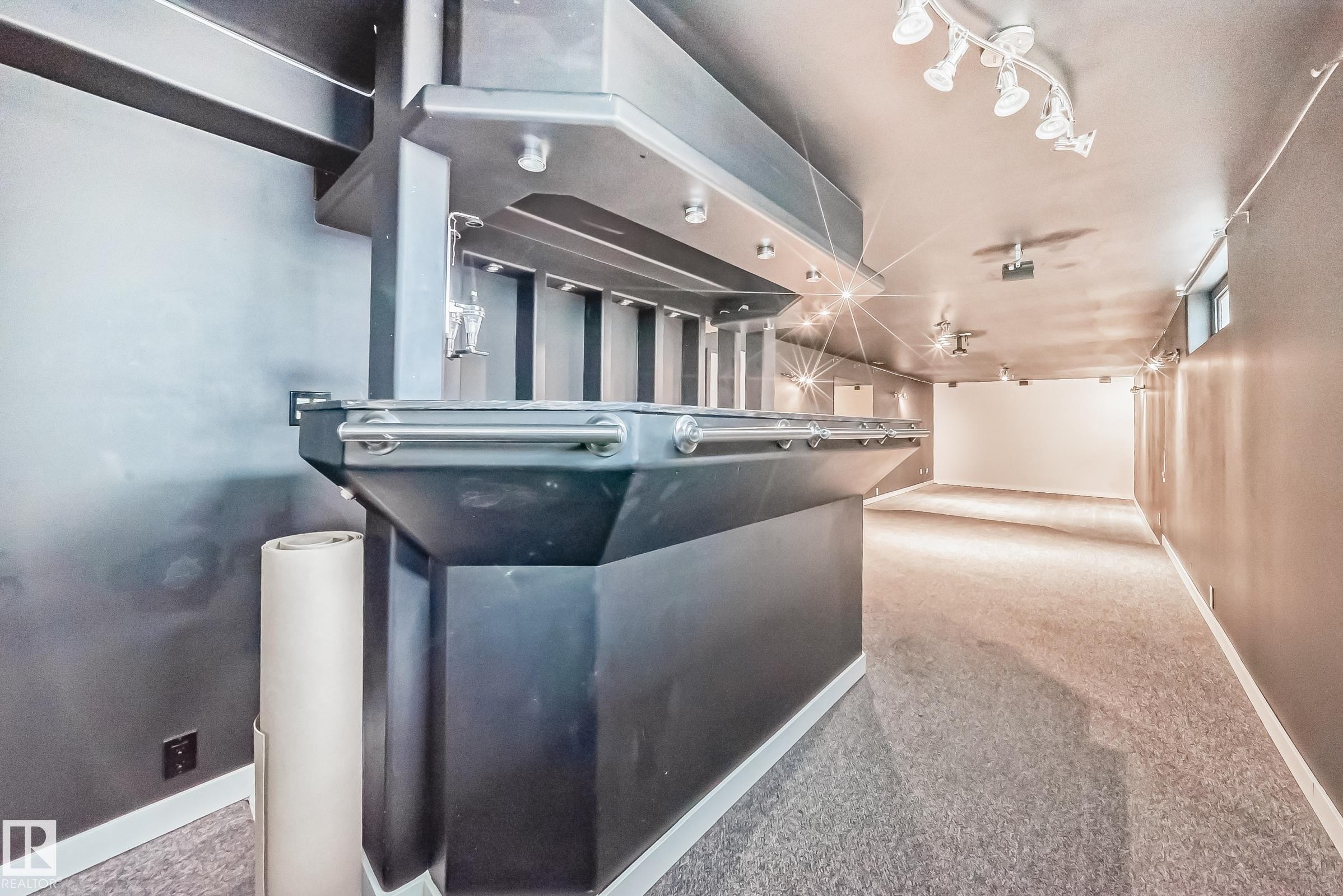 Built-in bar featuring integrated lighting, stainless steel accents, and dark cabinetry - 5204 112 Avenue Nw, Edmonton, AB - Indoor Photo Showing Other Room
