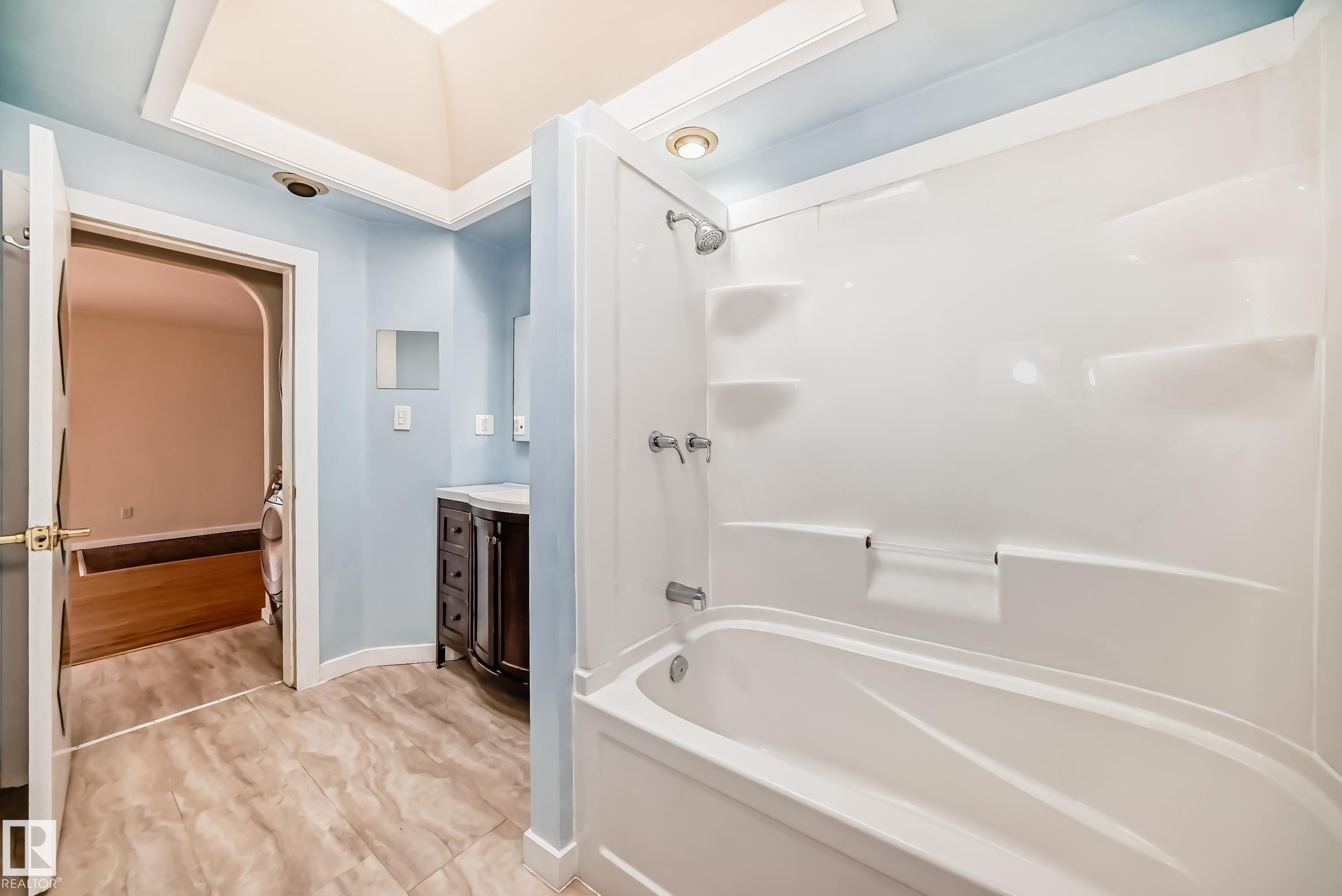 White tub and shower combination with chrome fixtures - 5204 112 Avenue Nw, Edmonton, AB - Indoor Photo Showing Bathroom