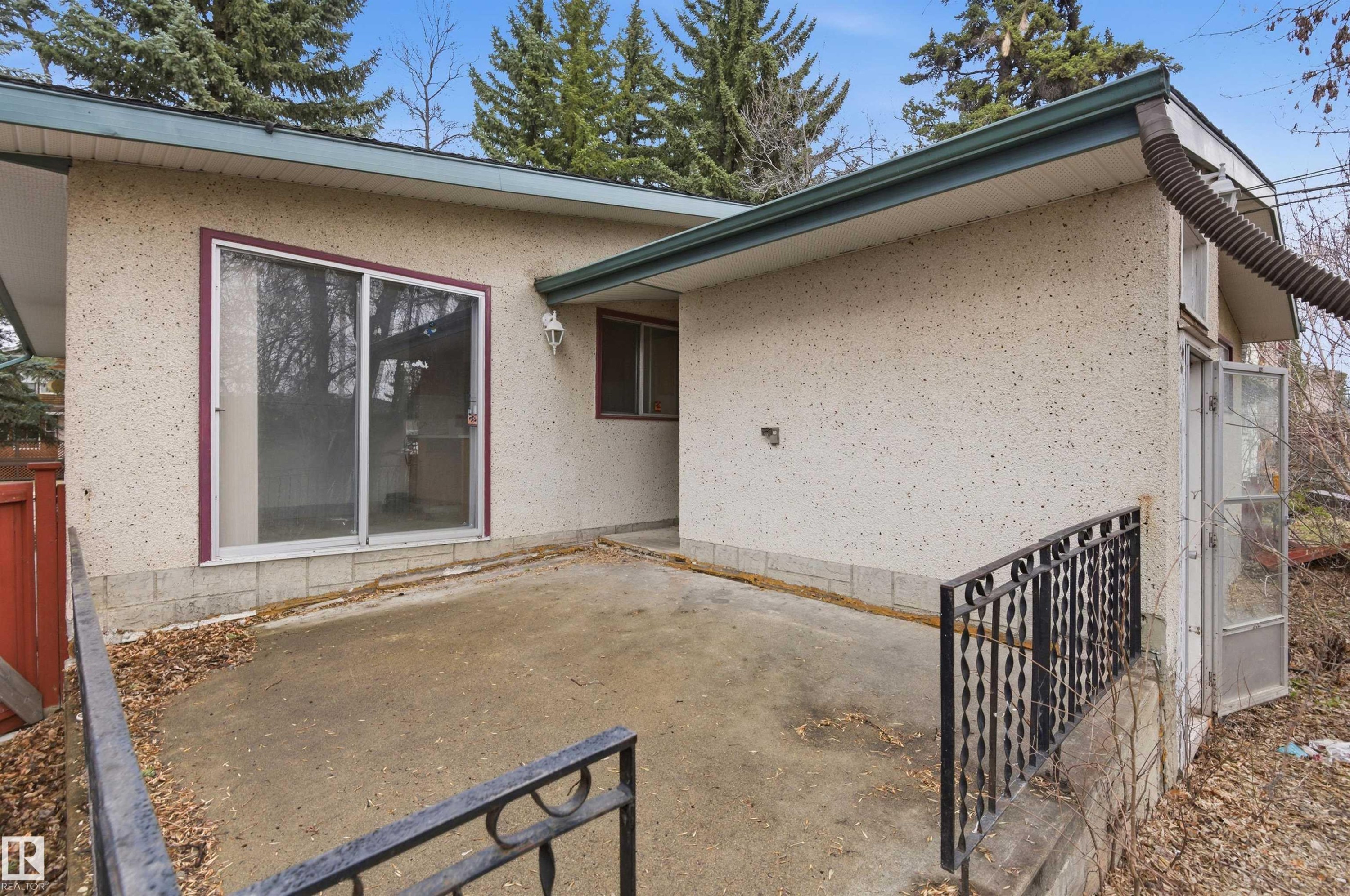 Concrete patio featuring wrought iron railings - 11211 77 Avenue, Edmonton, AB - Outdoor With Exterior