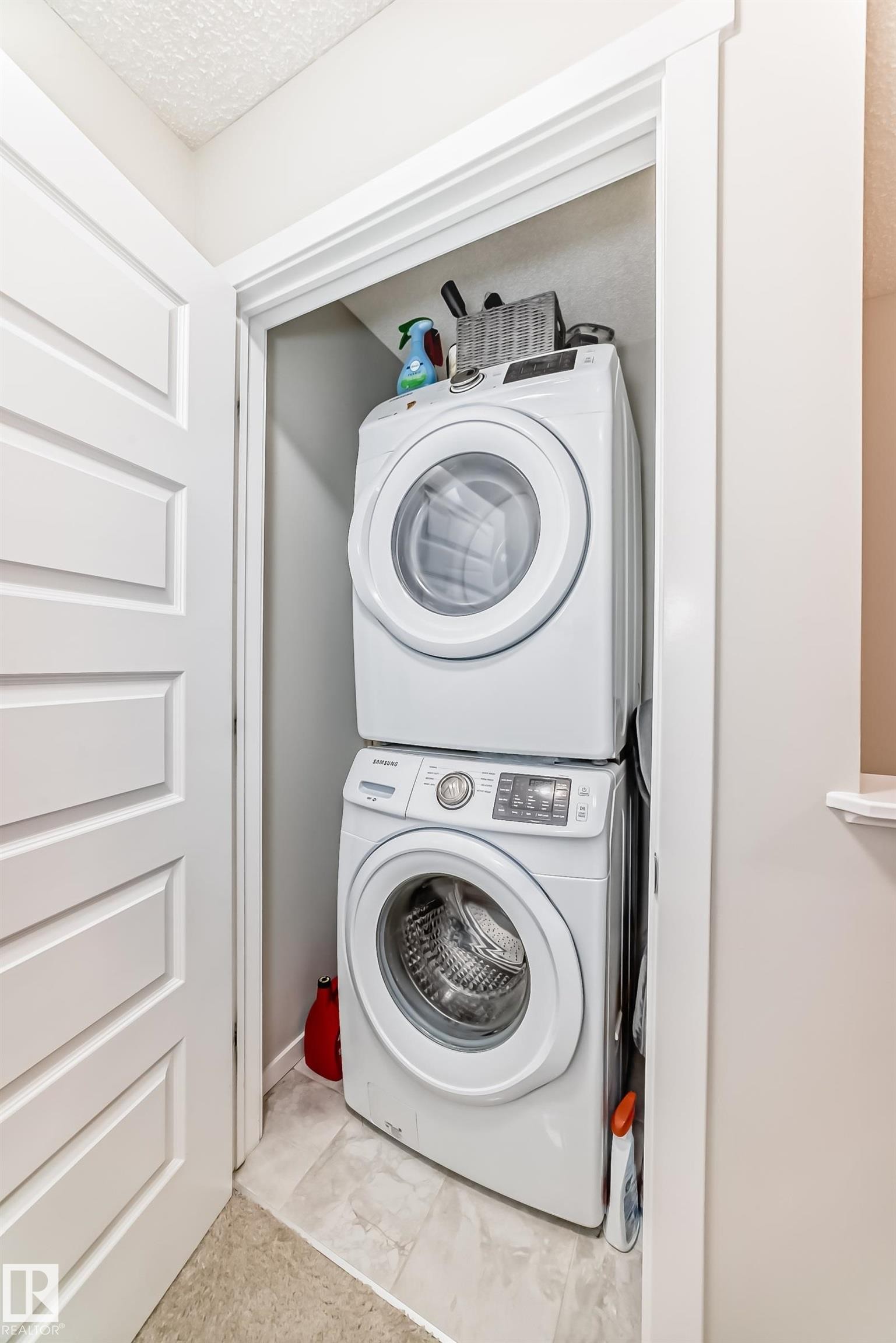 Dedicated laundry closet featuring a stacked washer and dryer unit - 3278 Cherry Crescent, Edmonton, AB - Indoor Photo Showing Laundry Room
