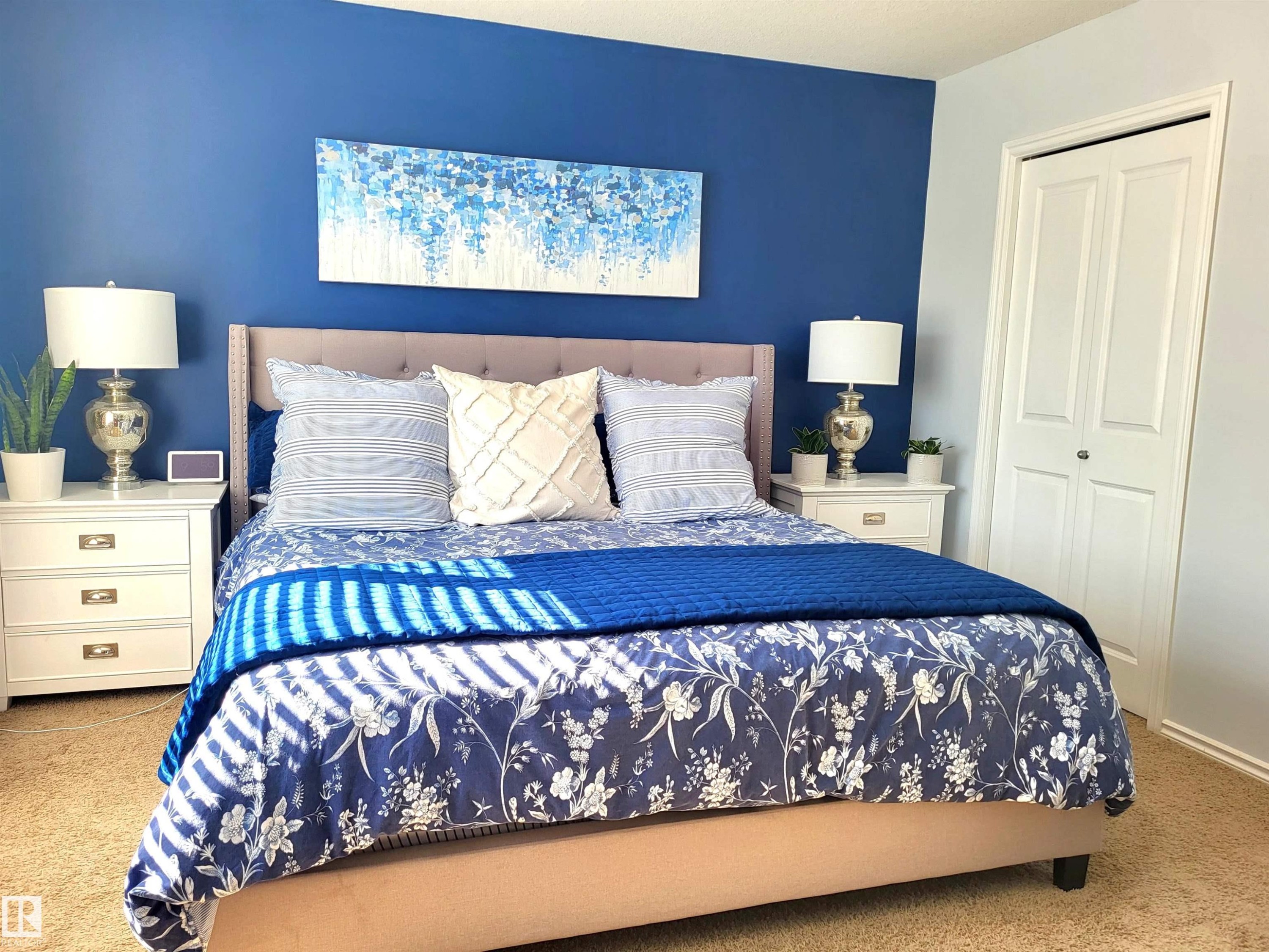 Bedroom featuring a deep blue accent wall and neutral carpeting - 144 Kirpatrick Way, Leduc, AB - Indoor Photo Showing Bedroom