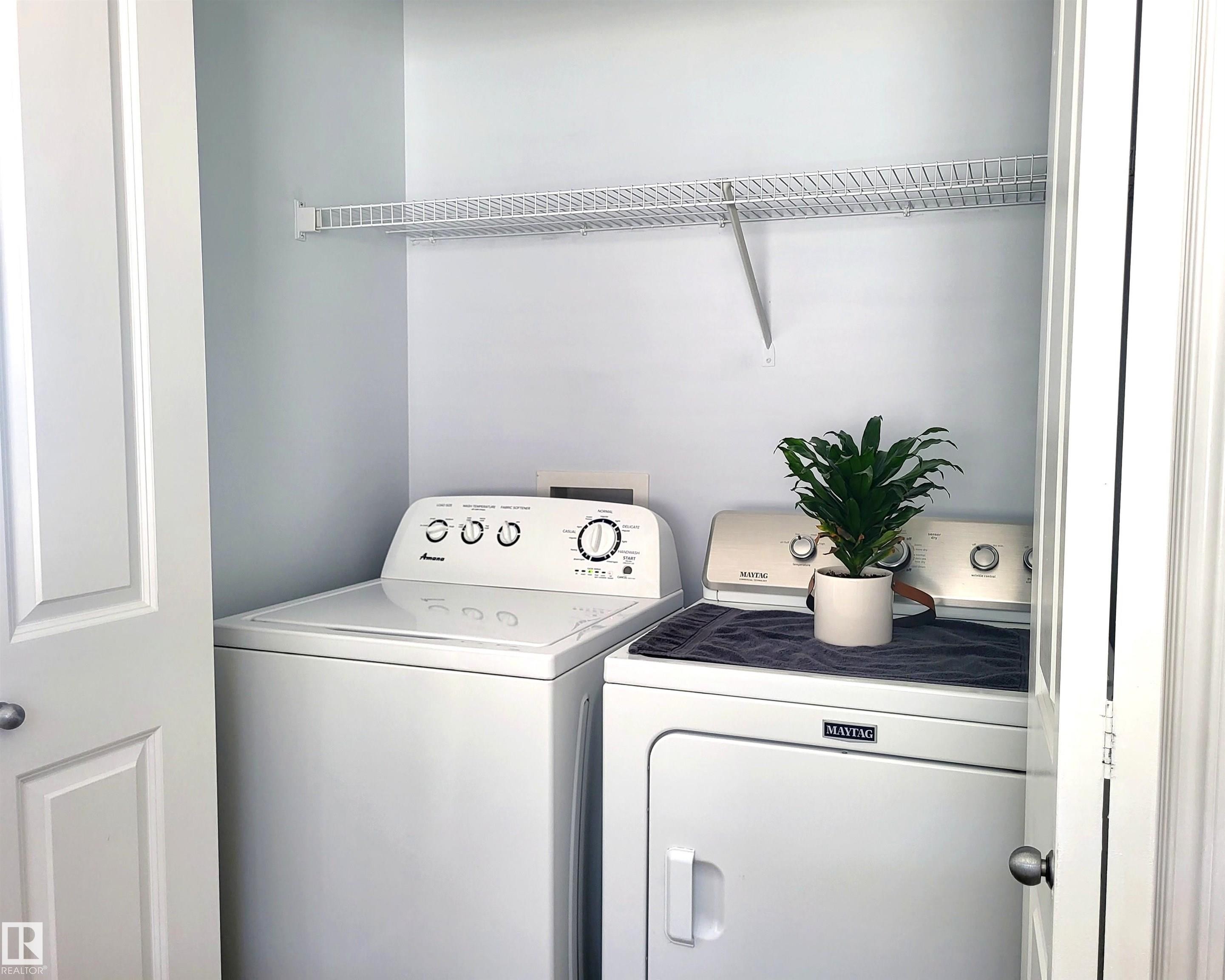 Dedicated laundry closet featuring a wire shelving unit, providing storage - 144 Kirpatrick Way, Leduc, AB - Indoor Photo Showing Laundry Room