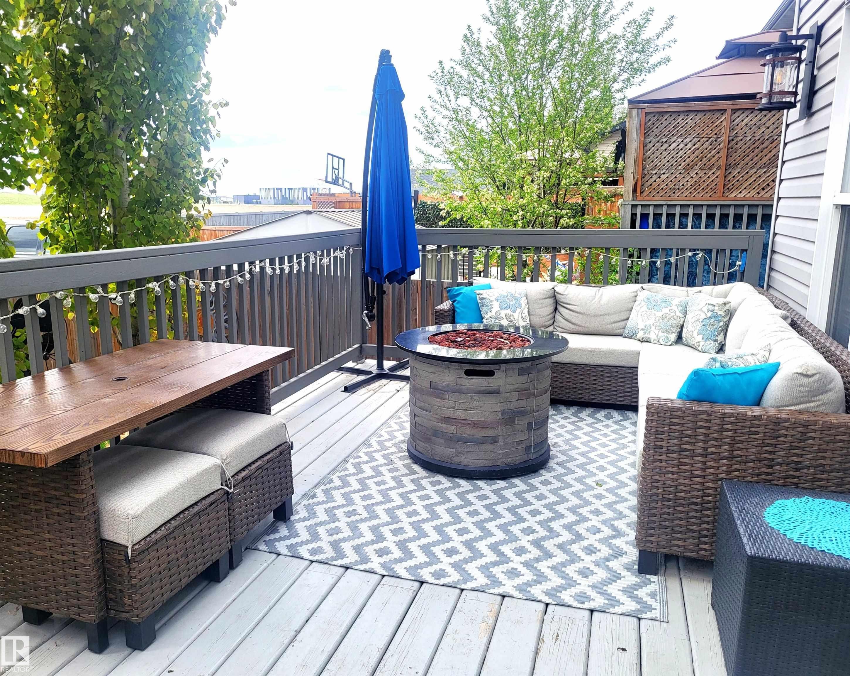 Spacious outdoor deck featuring gray wood-finish flooring and a matching gray railing - 144 Kirpatrick Way, Leduc, AB - Outdoor With Deck Patio Veranda With Exterior