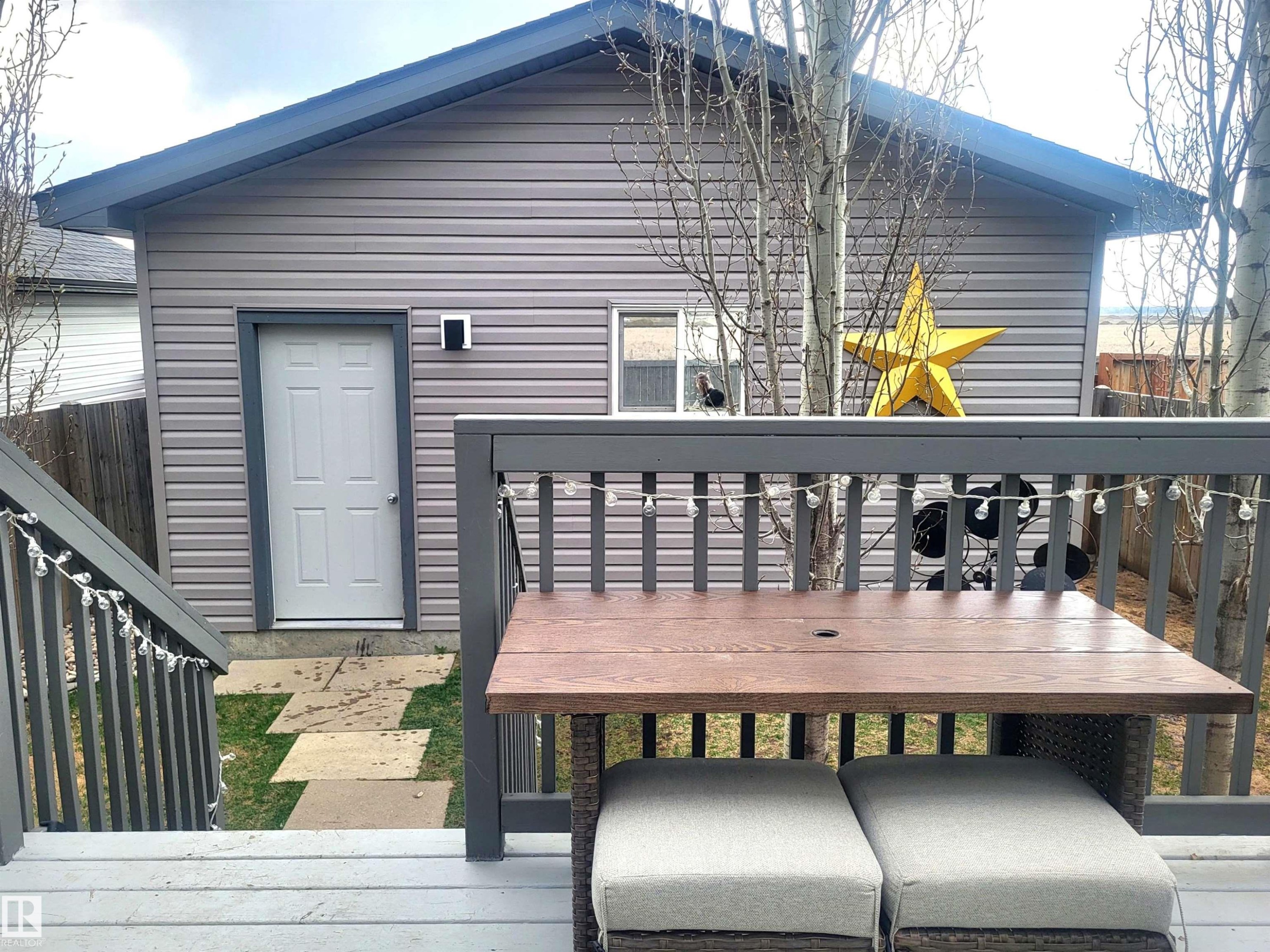 Rear structure featuring horizontal siding and a dark roofline - 144 Kirpatrick Way, Leduc, AB - Outdoor With Deck Patio Veranda With Exterior