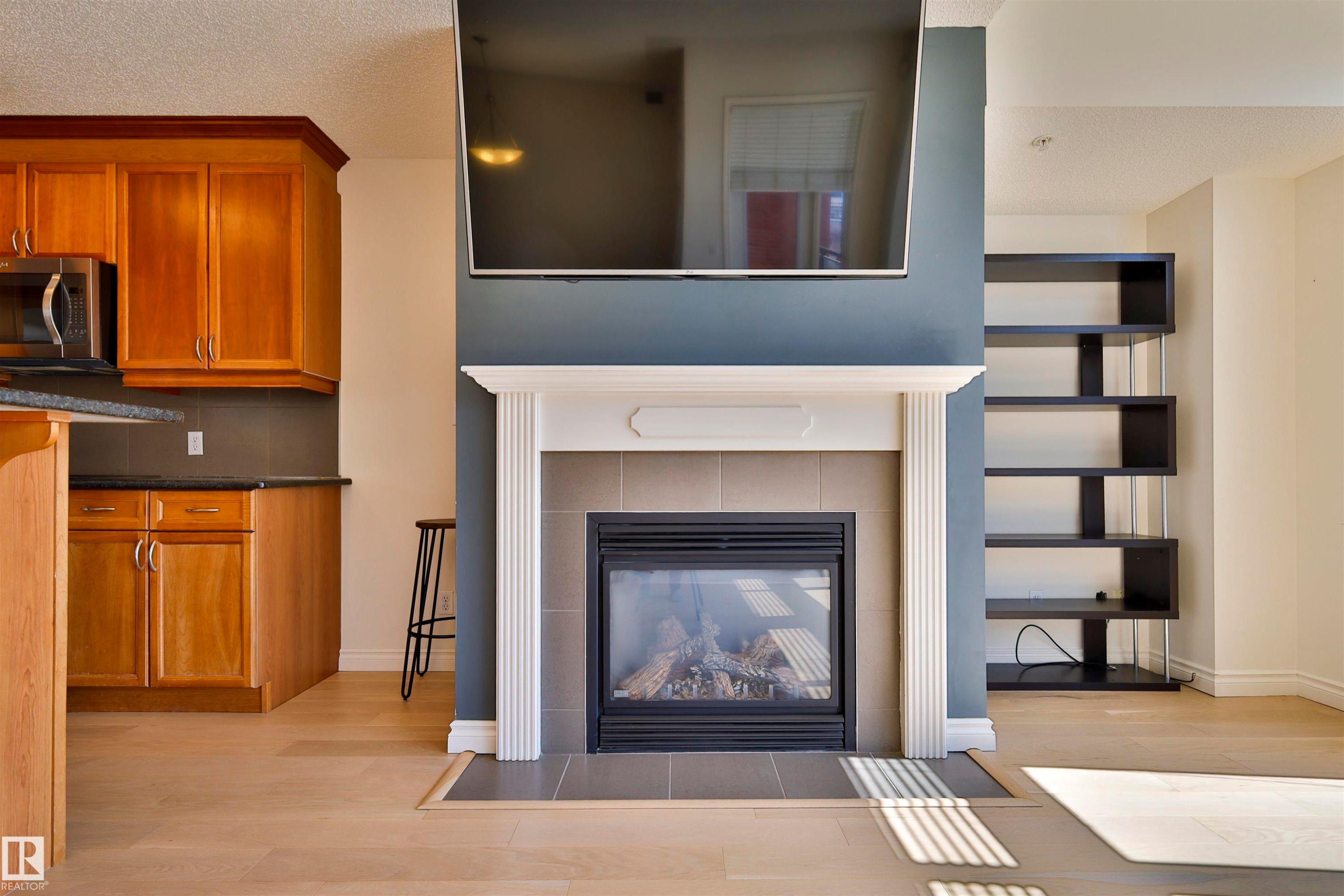 906 9020 Jasper Avenue, Edmonton, AB - Indoor Photo Showing Living Room With Fireplace