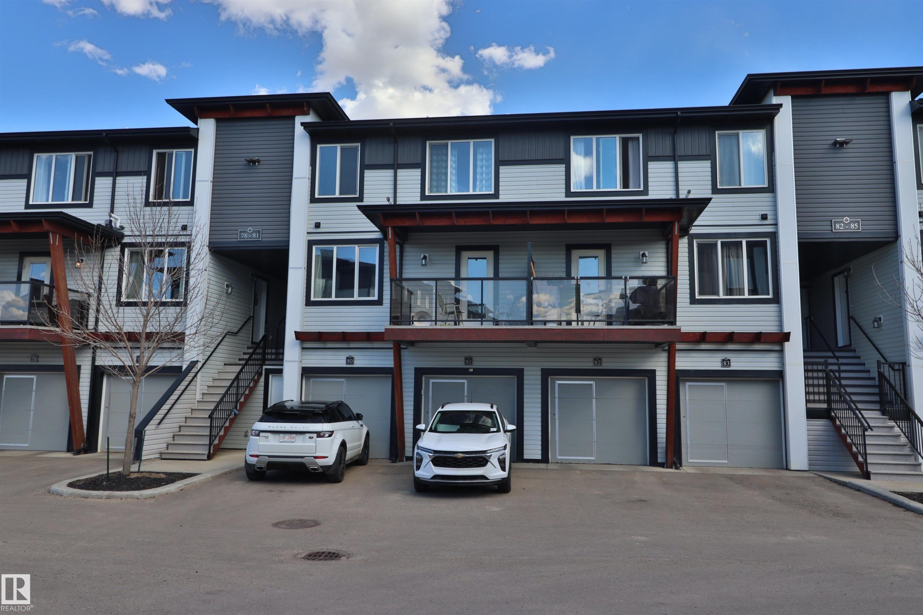 Modern multi-story residential building featuring light grey and dark grey siding - 81 446 Allard Blvd, Edmonton, AB - Outdoor With Facade