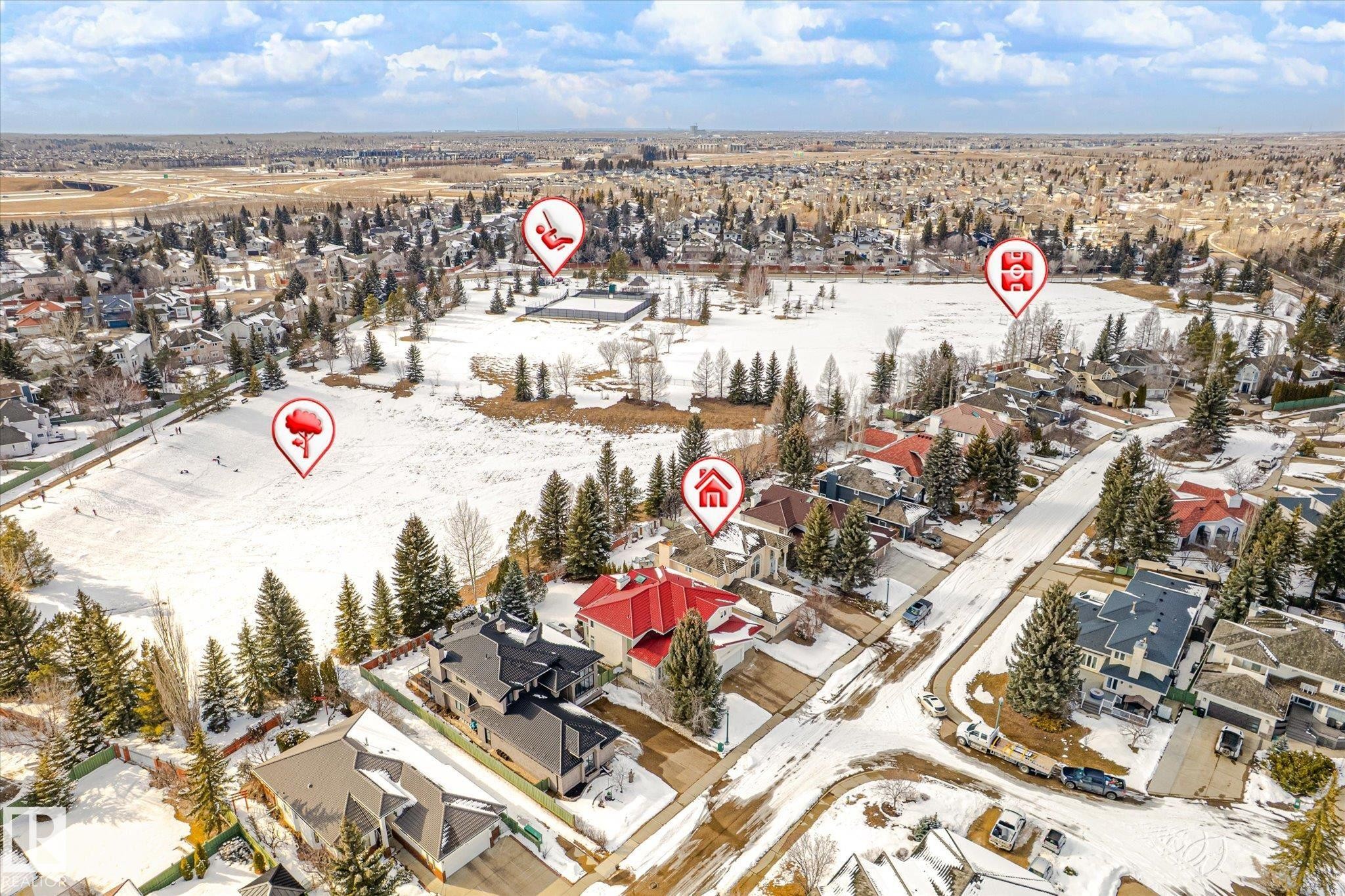 Aerial view showcasing the property situated within a developed neighborhood featuring snow-covered landscapes, mature trees, and a visible street - 128 Weaver Drive, Edmonton, AB - Outdoor With View