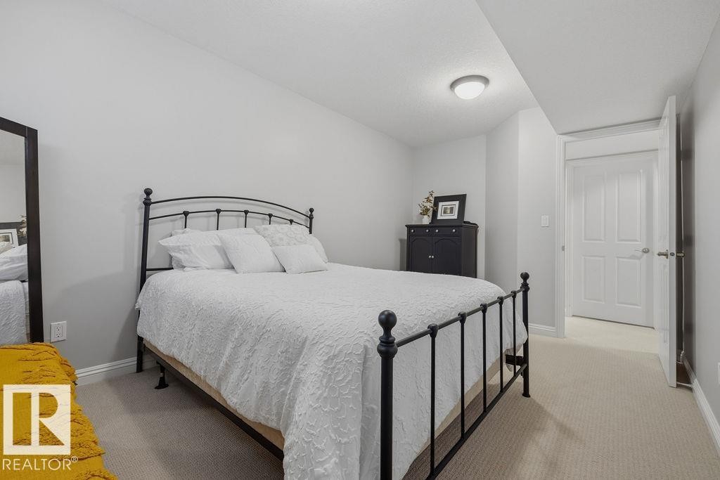 Bedroom with light gray walls, neutral carpeting, and a flush-mount ceiling light fixture - 1613 Kerr Road, Edmonton, AB - Indoor Photo Showing Bedroom