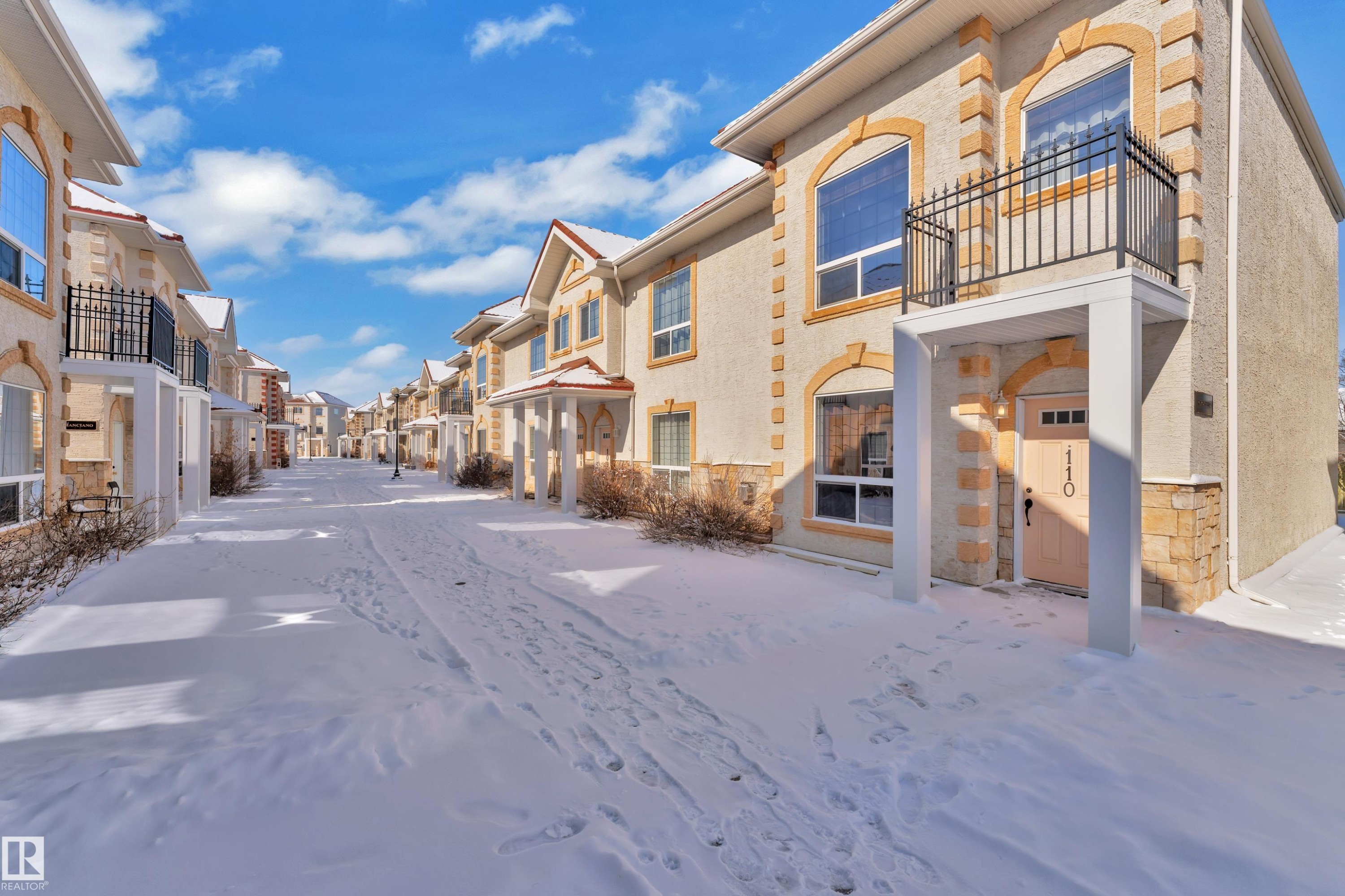 Stucco exterior with stone accents and arched window details - 110 13825 155, Edmonton, AB - Outdoor