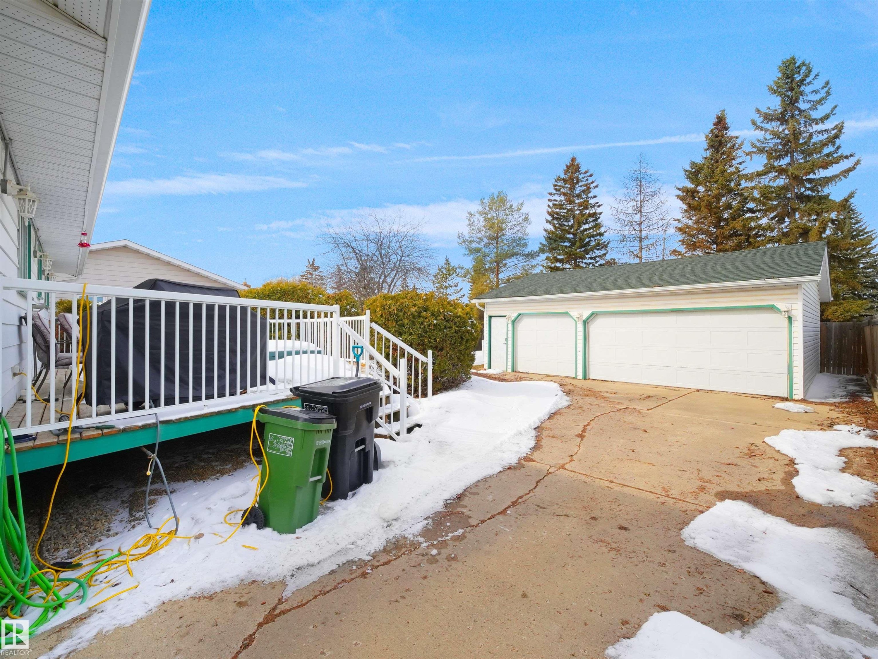 Detached two-car garage with green trim and a paved driveway - 11044 166 Avenue, Edmonton, AB - Outdoor With Exterior