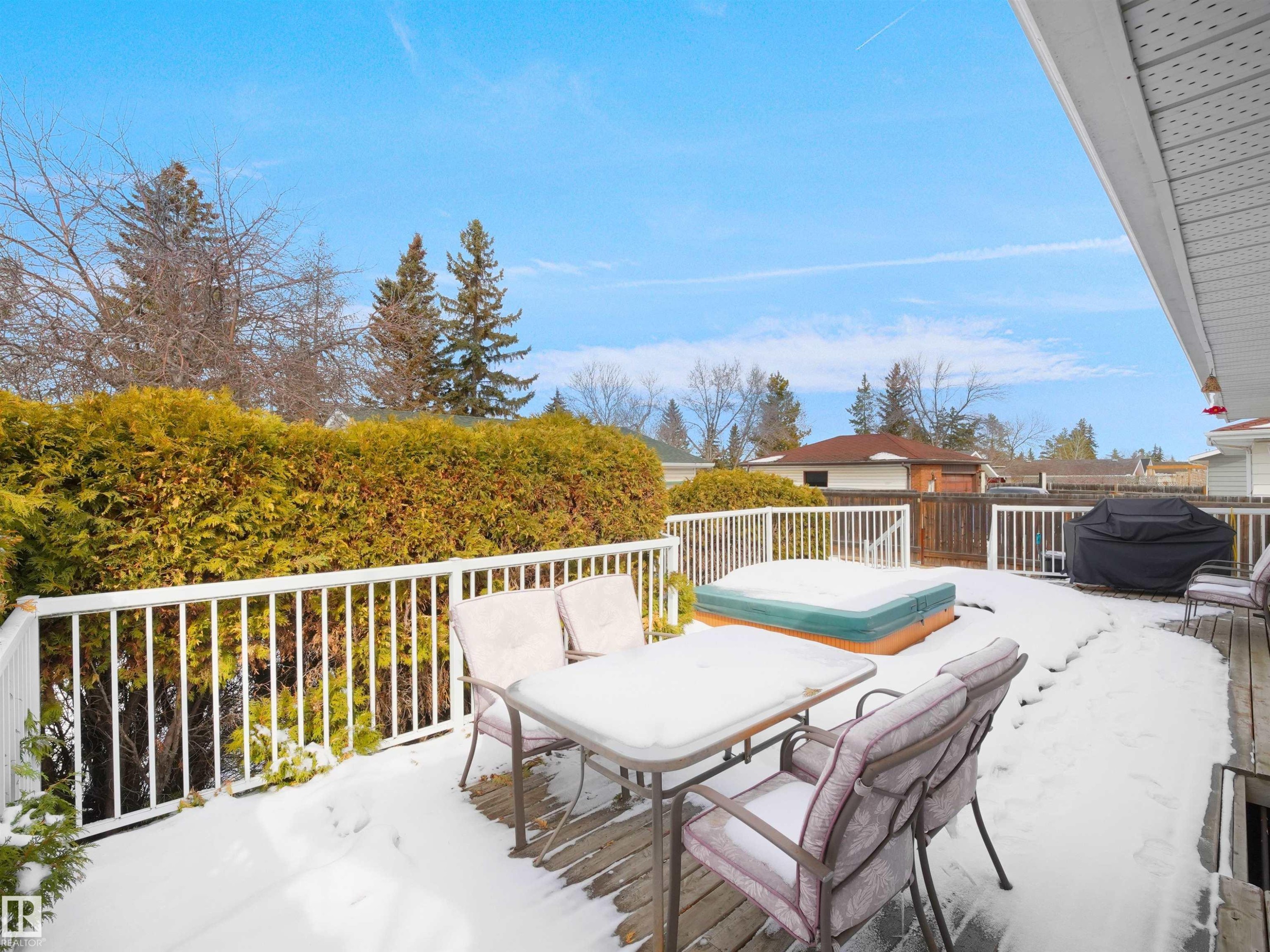Expansive wooden deck with white railing, featuring a built-in hot tub - 11044 166 Avenue, Edmonton, AB - Outdoor With Deck Patio Veranda With Exterior