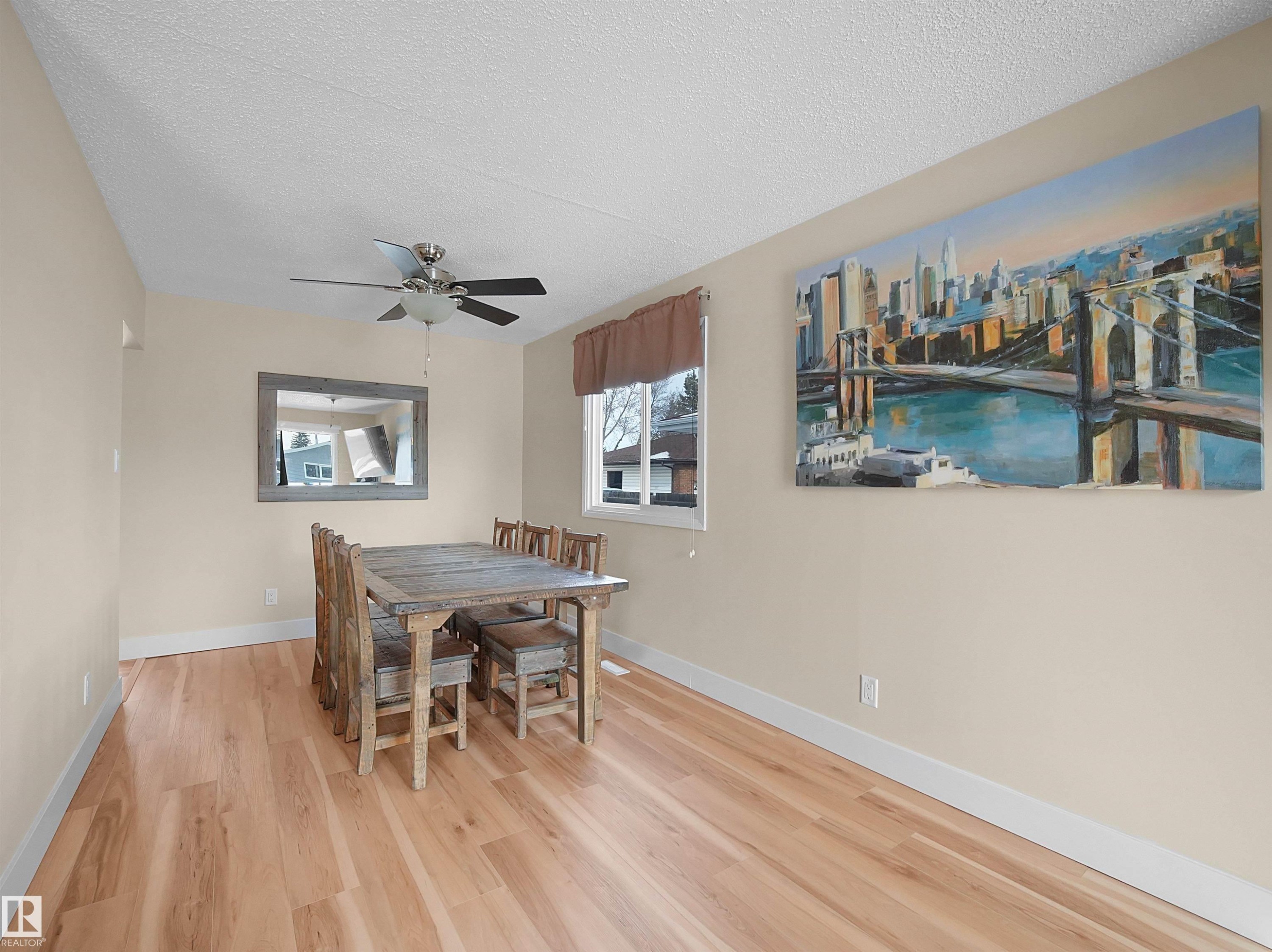 Spacious room with light wood-finish flooring, neutral wall paint, and white baseboards - 11044 166 Avenue, Edmonton, AB - Indoor Photo Showing Dining Room