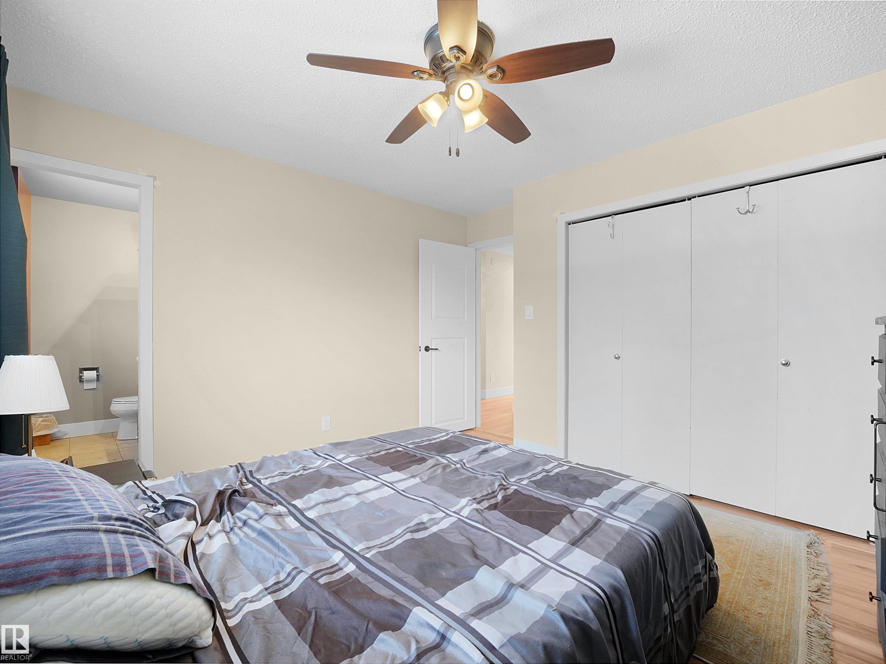 Light-toned walls with wood-finish flooring - 11044 166 Avenue, Edmonton, AB - Indoor Photo Showing Bedroom