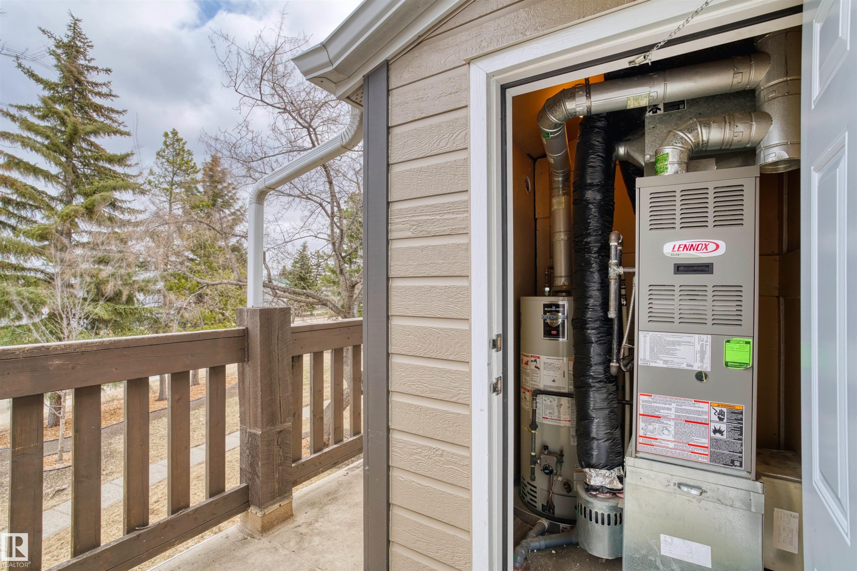 Exterior utility closet housing a Lennox furnace and water heater - 1116 Saddleback Road, Edmonton, AB - With Exterior