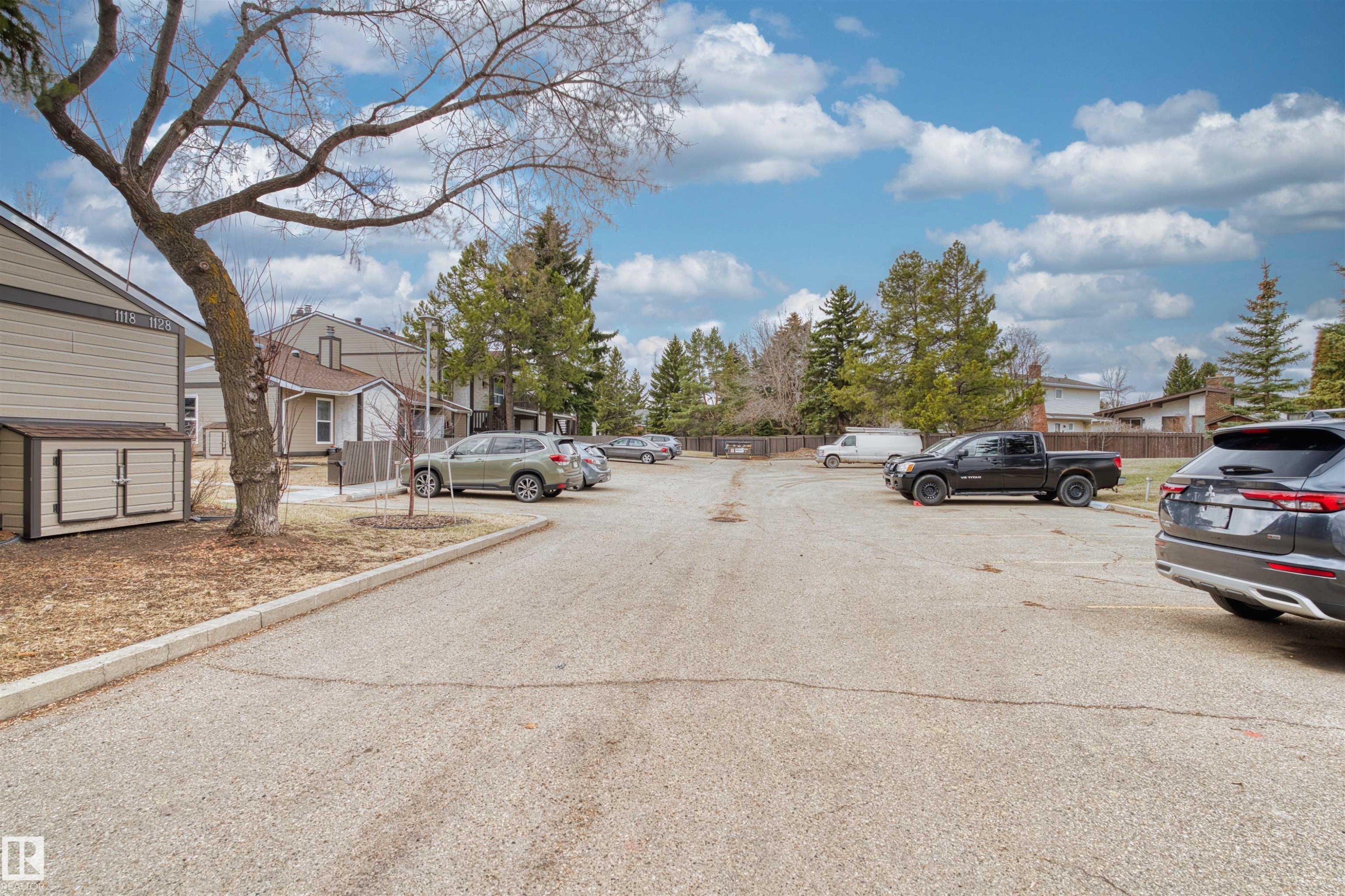 Paved parking area with multiple spaces and surrounding mature trees - 1116 Saddleback Road, Edmonton, AB - Outdoor