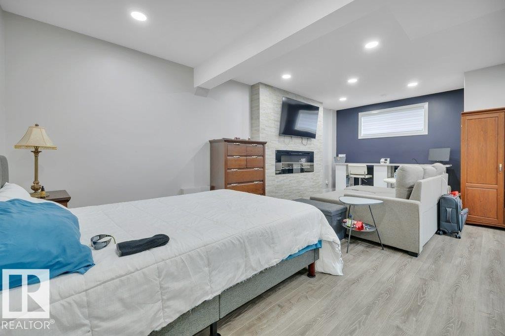 100 Aston Bend, Leduc, AB - Indoor Photo Showing Bedroom With Fireplace