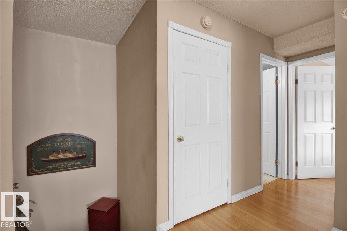 The property features light-colored walls and hardwood flooring throughout - 412 2908 116A Avenue, Edmonton, AB - Indoor Photo Showing Other Room