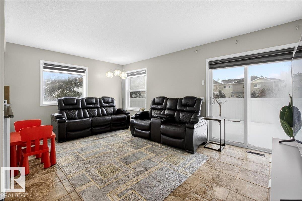 Living area with stone tile flooring - 47 230 Edwards Drive, Edmonton, AB - Indoor Photo Showing Living Room