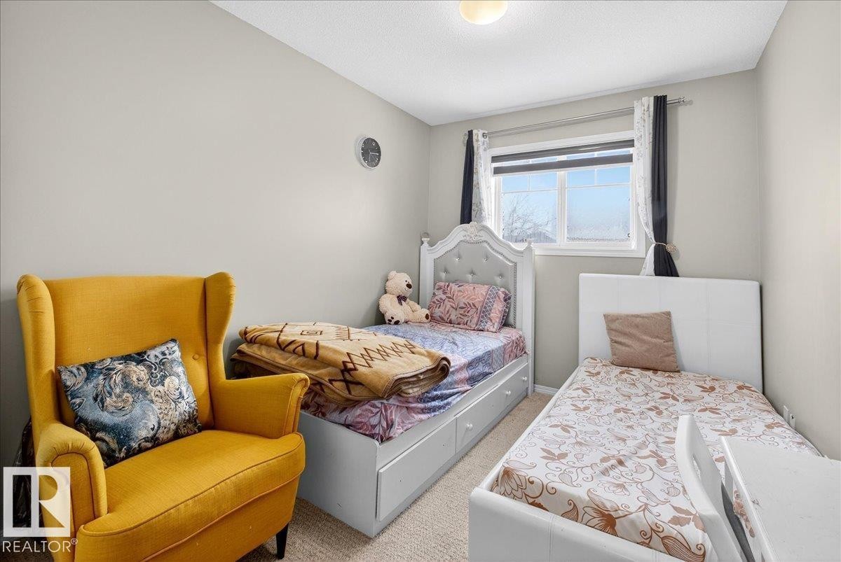 Carpeted bedroom with a textured ceiling - 47 230 Edwards Drive, Edmonton, AB - Indoor Photo Showing Bedroom