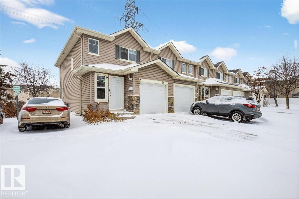 Traditional-style house featuring stone siding - 47 230 Edwards Drive, Edmonton, AB - Outdoor With Facade