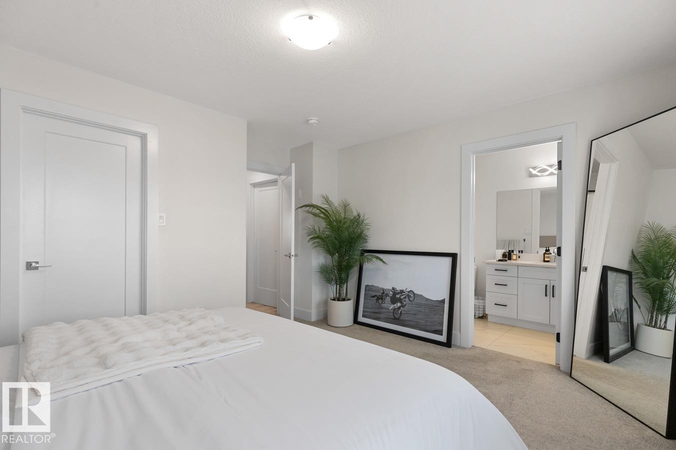 Carpeted room with white walls, two flat panel doors, and a ceiling-mounted light fixture - 6023 180 Avenue, Edmonton, AB - Indoor Photo Showing Bedroom