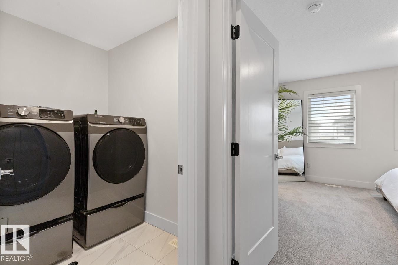 Dedicated laundry area featuring tile flooring and light-toned walls - 6023 180 Avenue, Edmonton, AB - Indoor Photo Showing Laundry Room