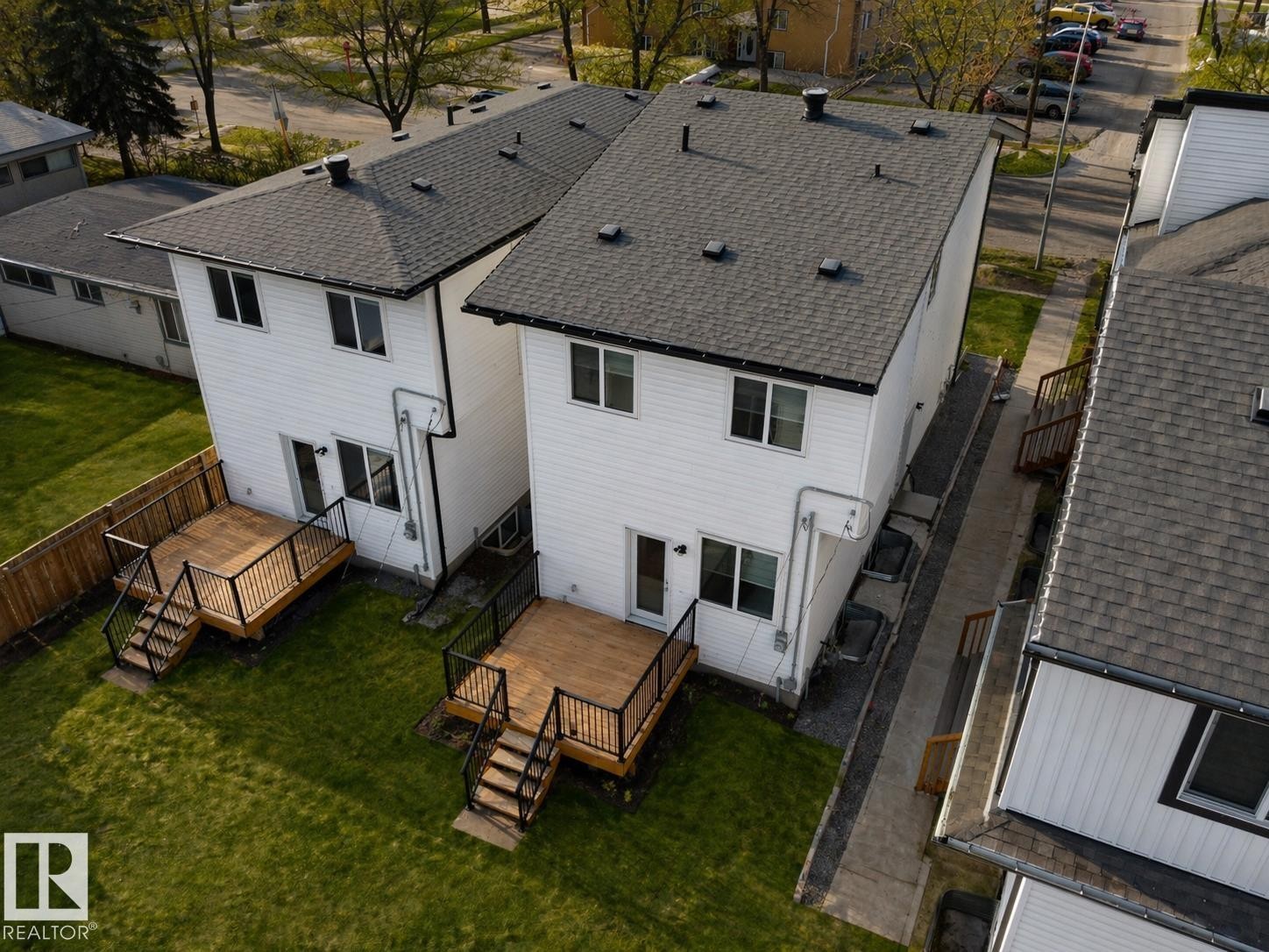 Pair of modern residences featuring white siding and dark shingle roofs - 10913 159 Street, Edmonton, AB - Outdoor