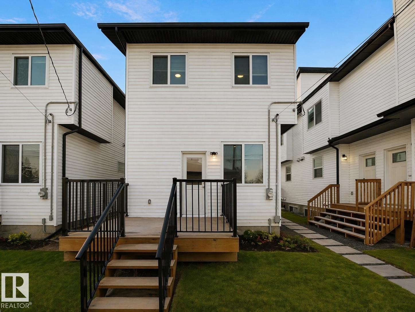 Rear exterior featuring white horizontal siding and black trim - 10913 159 Street, Edmonton, AB - Outdoor With Deck Patio Veranda With Exterior