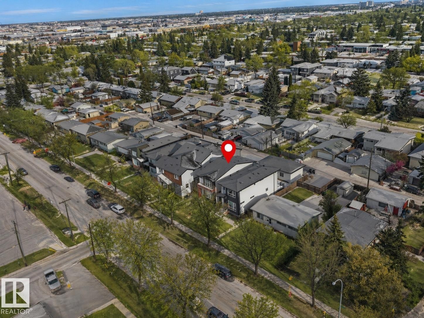 Modern multi-unit residential property with a dark shingle roof and white and dark grey exterior siding - 10913 159 Street, Edmonton, AB - Outdoor With View