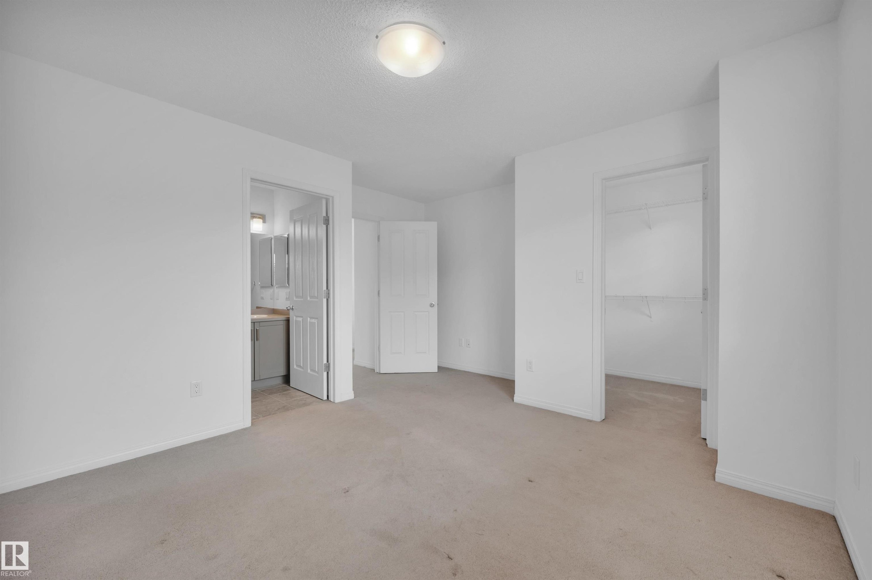 Carpeted room featuring light-colored walls and a flush-mount ceiling light - 13 1030 Chappelle Boulevard, Edmonton, AB - Indoor Photo Showing Other Room