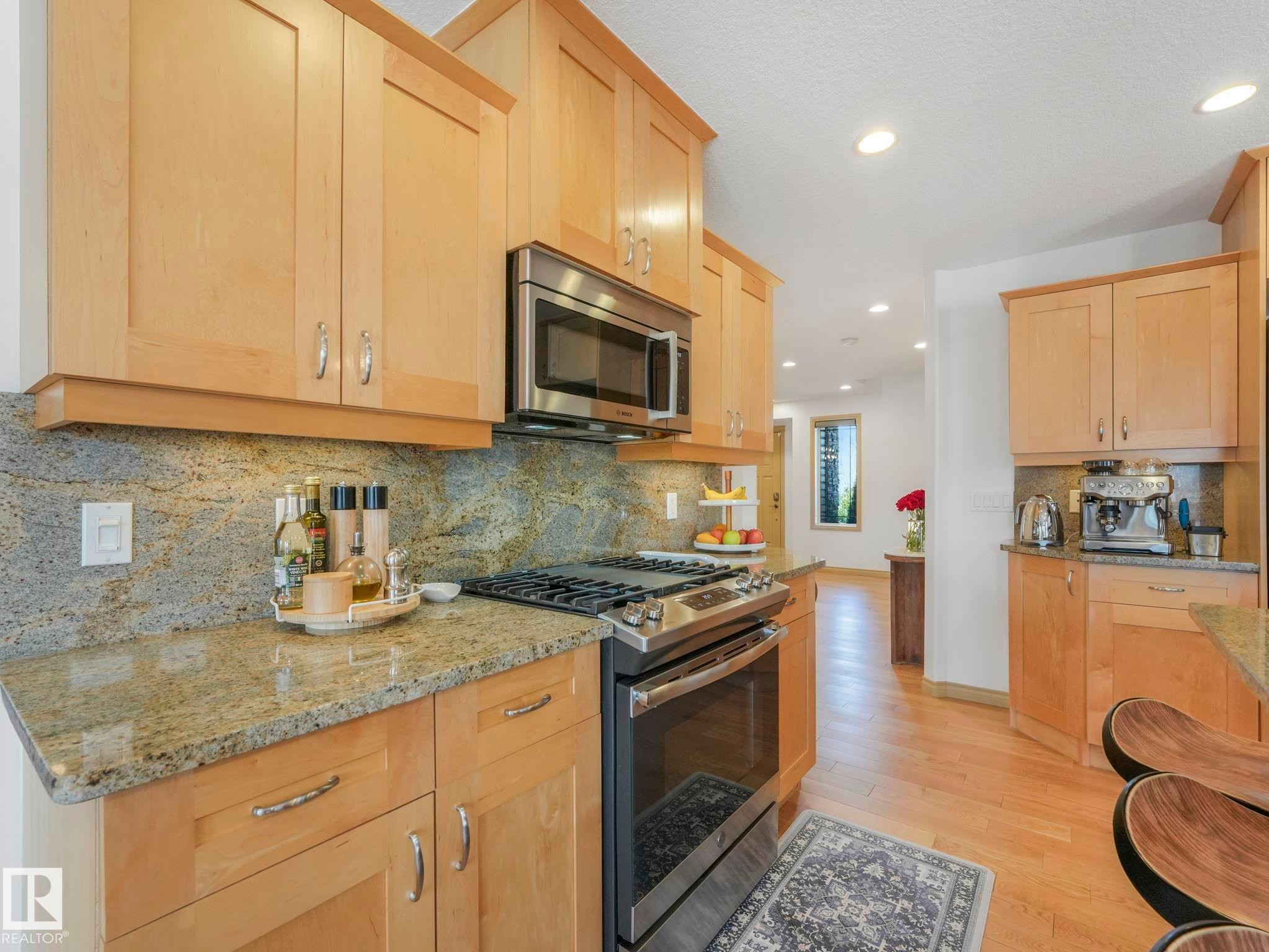 Granit countertops and backsplash, illuminated with under cabinet lighting throughout. - 8723 207 Street Nw, Edmonton, AB - Indoor Photo Showing Kitchen With Upgraded Kitchen