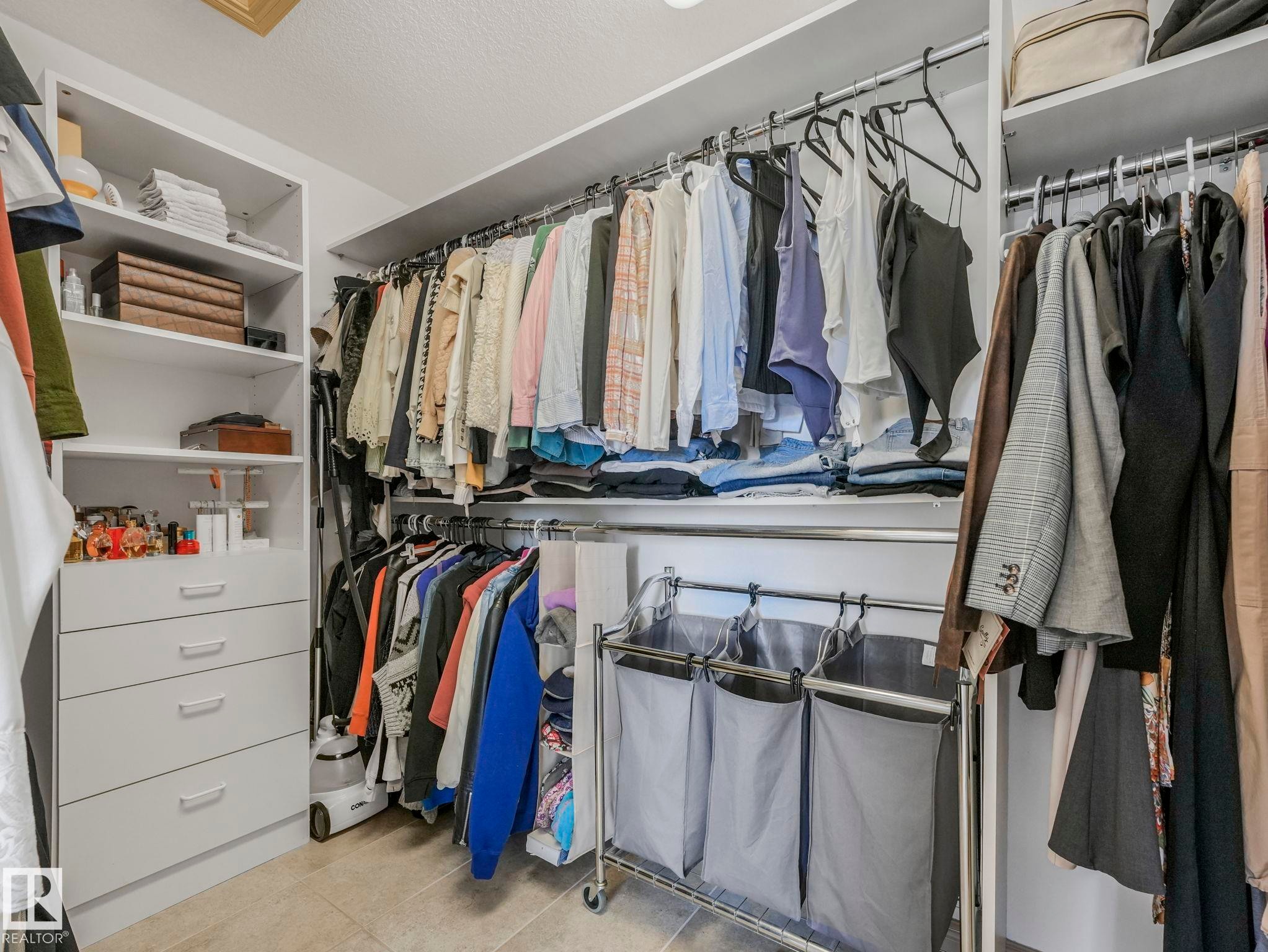 Walk in Closet features custom shelving and drawers - 8723 207 Street Nw, Edmonton, AB - Indoor With Storage