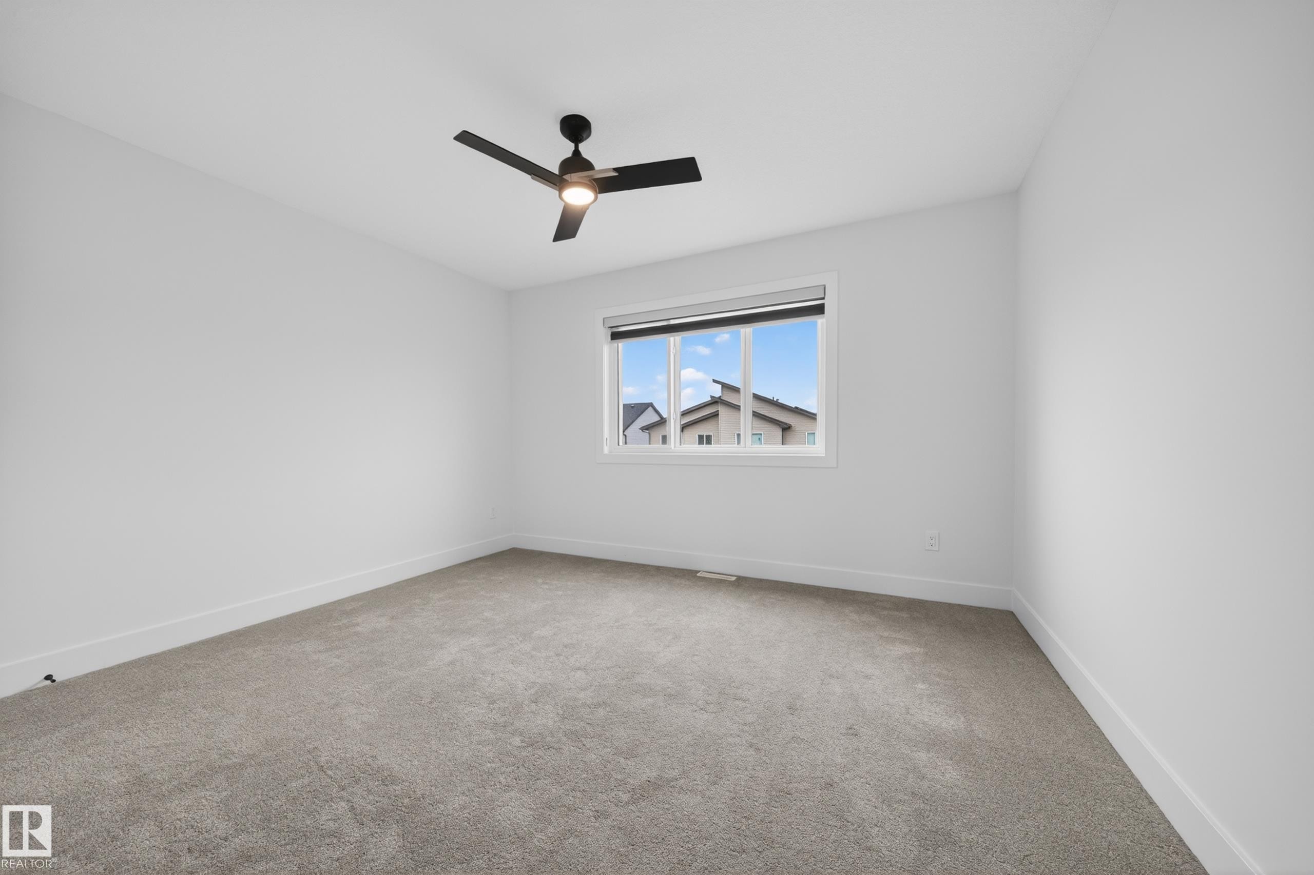 Spacious room with light gray carpeting and white walls - 7414 Chivers Crescent Sw, Edmonton, AB - Indoor Photo Showing Other Room