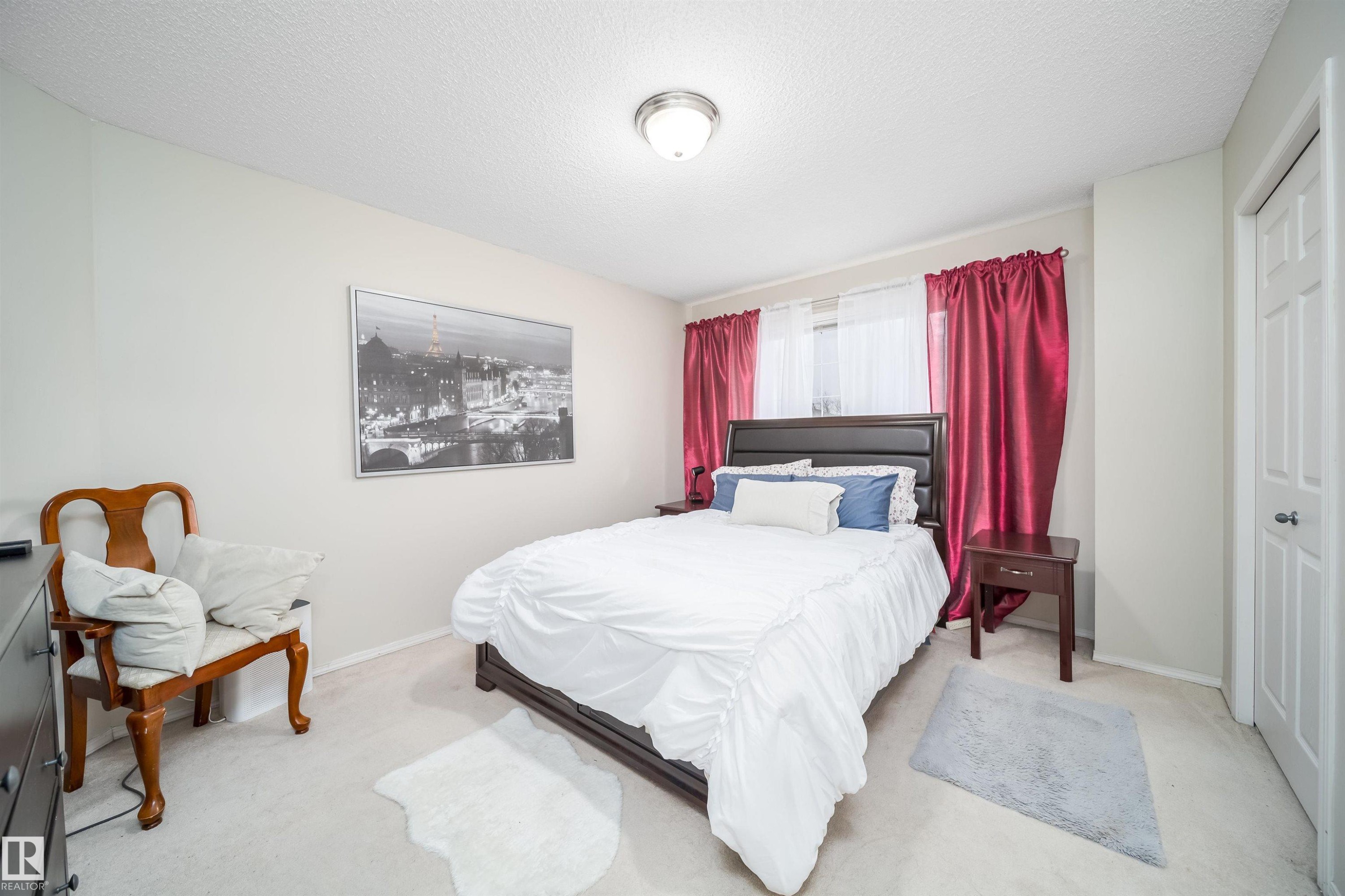Carpeted bedroom featuring neutral wall paint and a flush-mount ceiling light - 50 14603 Miller Boulevard, Edmonton, AB