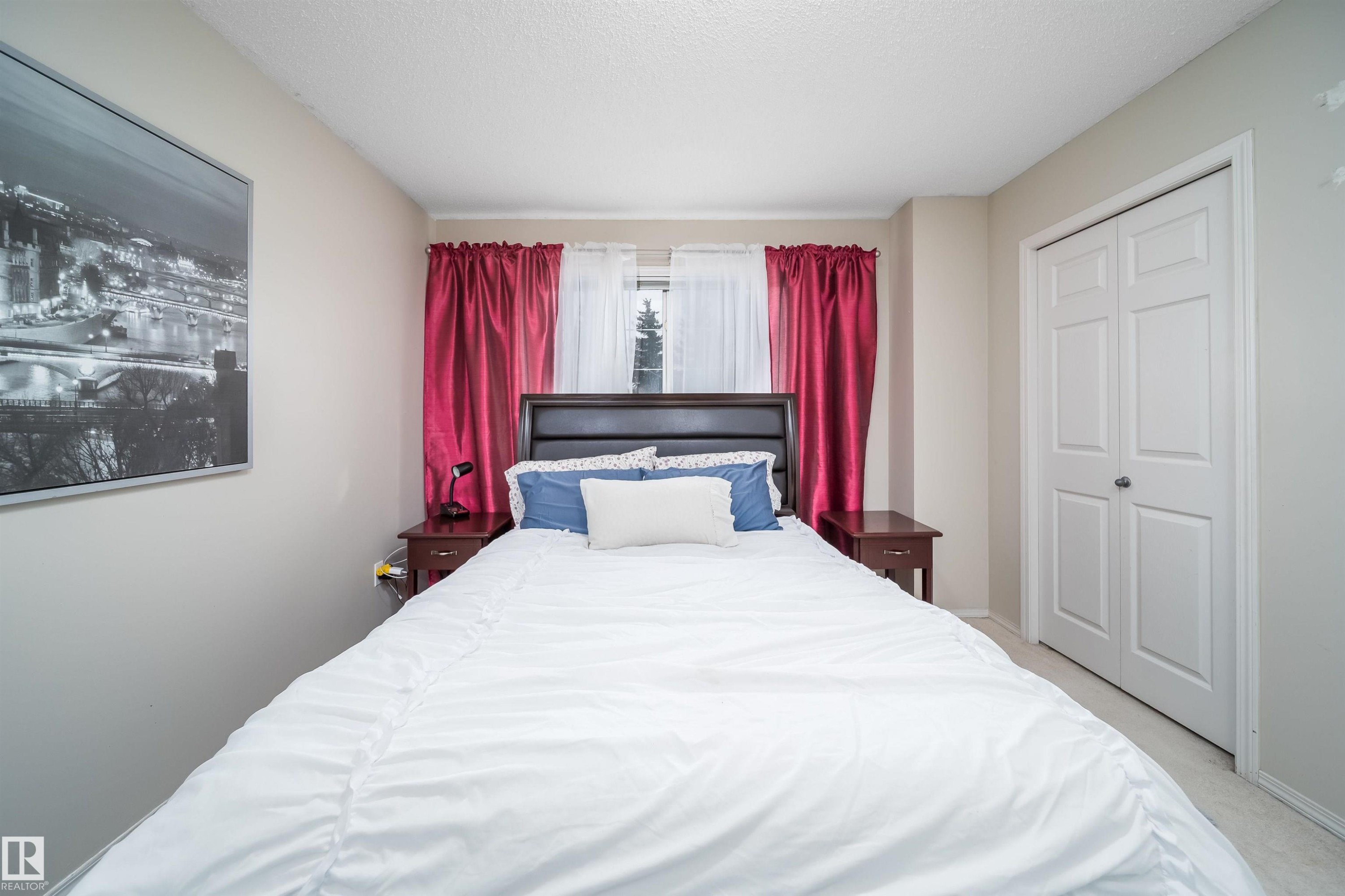 Bedroom featuring neutral wall paint and light-colored carpeting - 50 14603 Miller Boulevard, Edmonton, AB