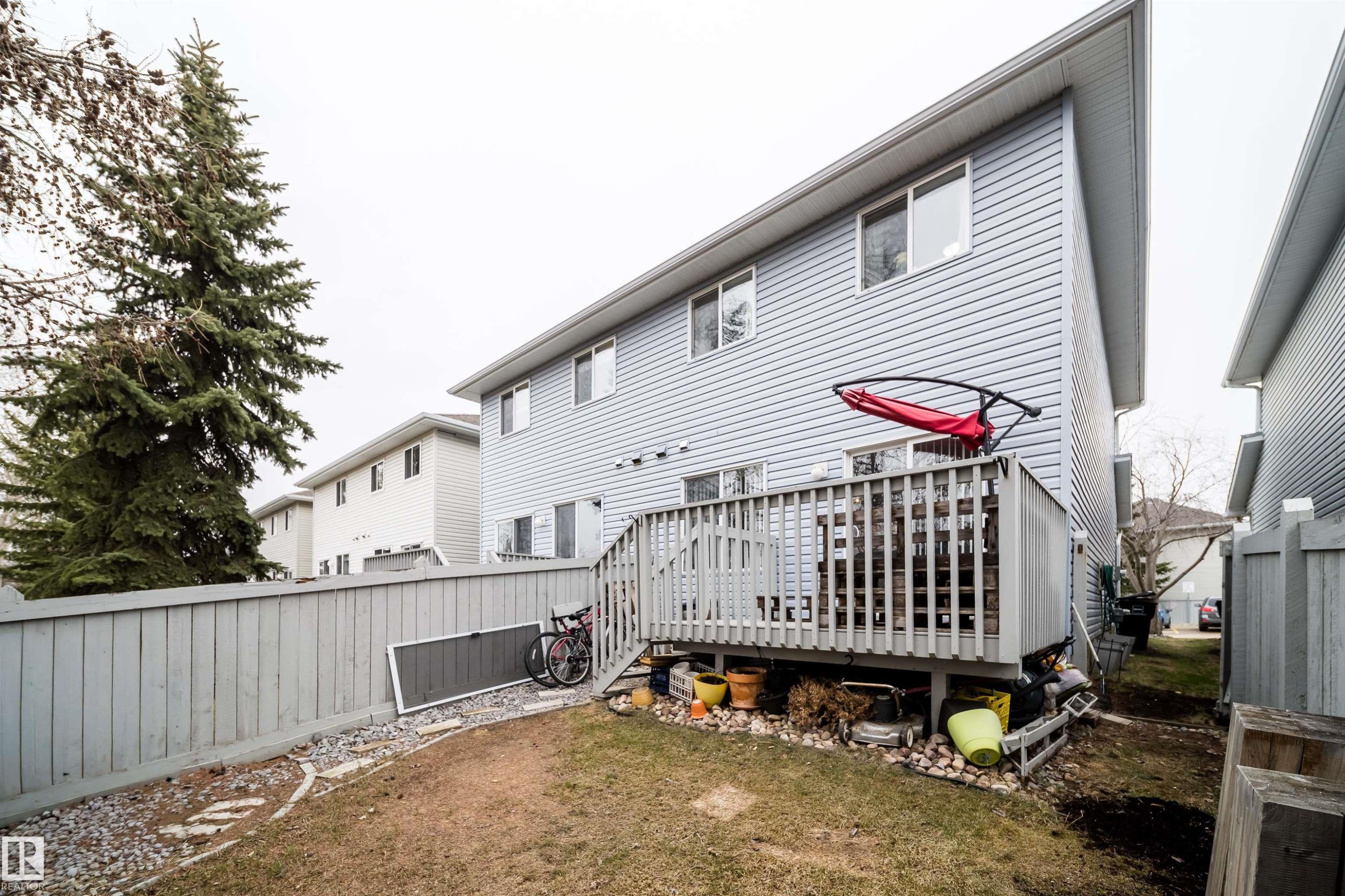 Rear exterior with light blue vinyl siding - 50 14603 Miller Boulevard, Edmonton, AB