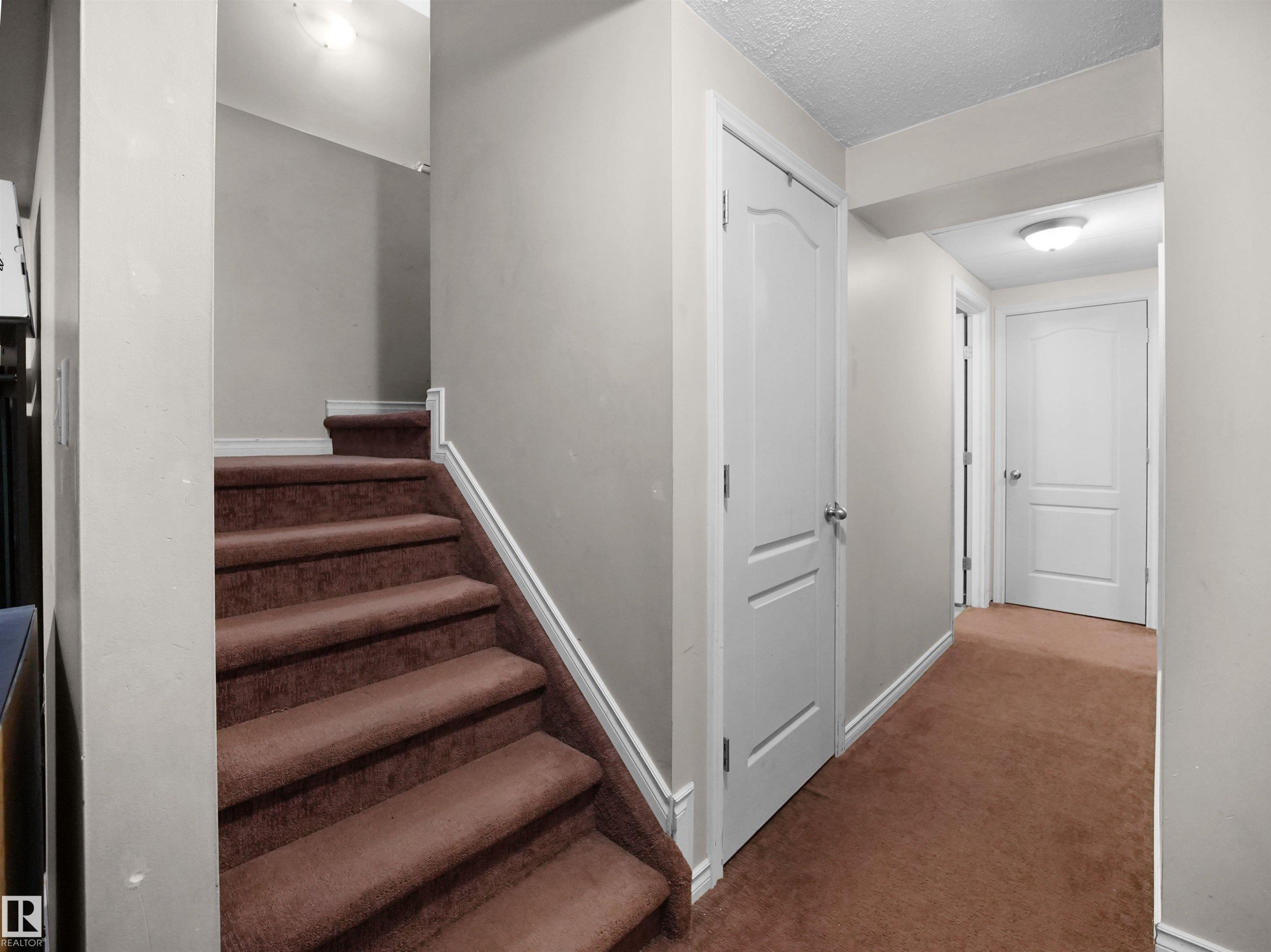 Carpeted staircase with white baseboards leading to an upper level - 21379 89 Avenue Nw, Edmonton, AB - Indoor Photo Showing Other Room