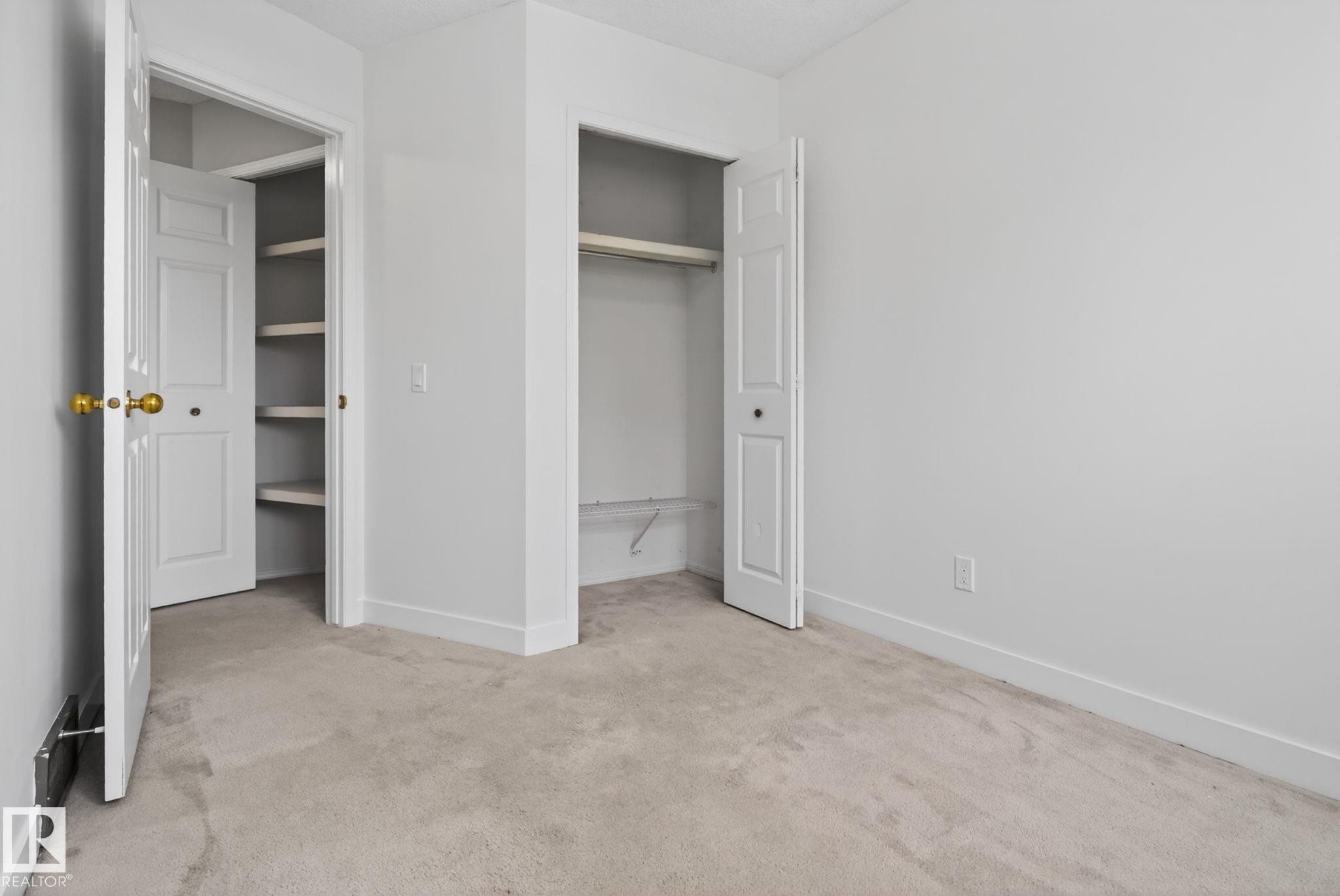 Neutral-toned carpeting paired with white walls - 18604 97A Avenue, Edmonton, AB - Indoor Photo Showing Other Room