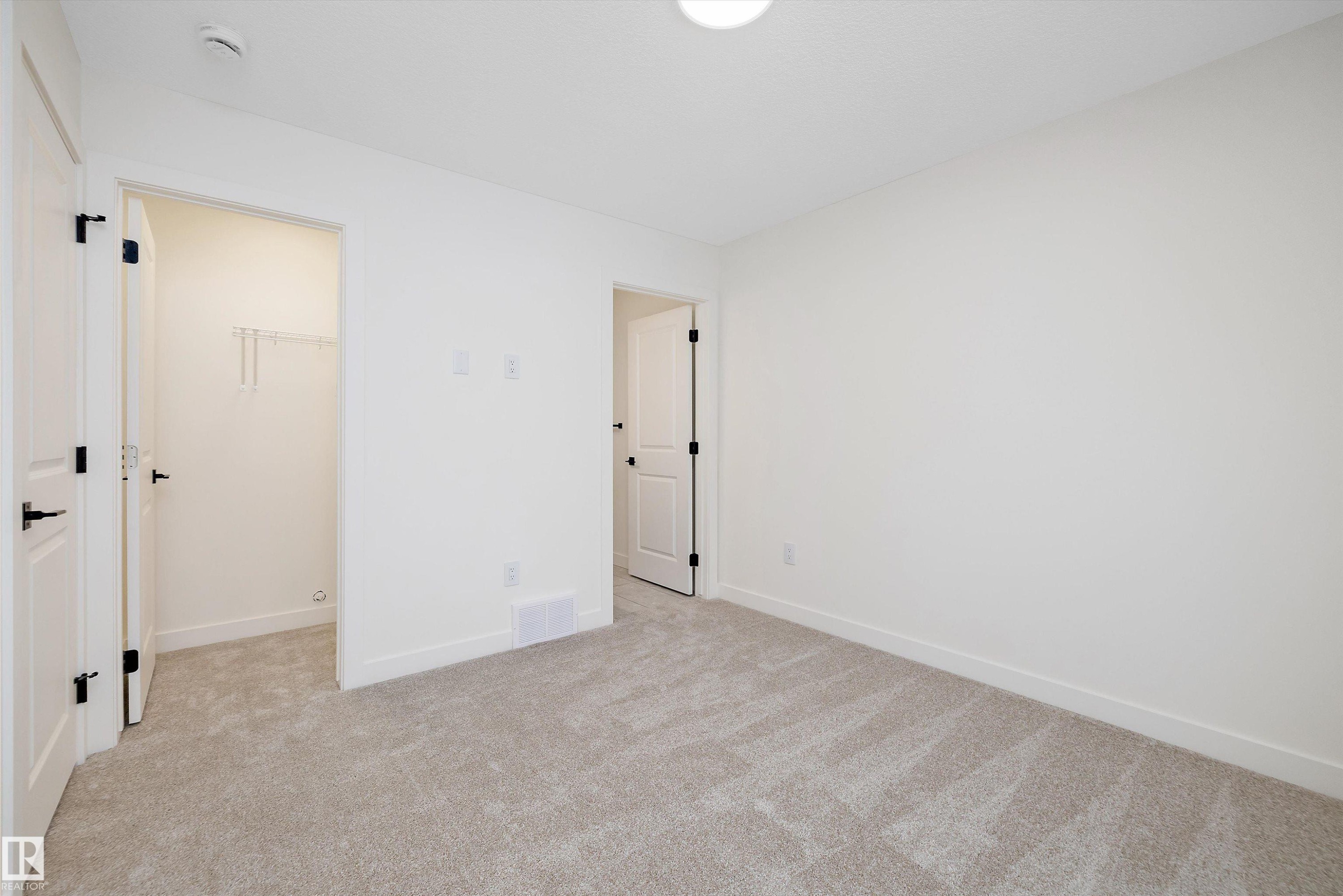 Carpeted room with white walls, baseboards, and ceiling - 11418 96 Street, Edmonton, AB - Indoor Photo Showing Other Room