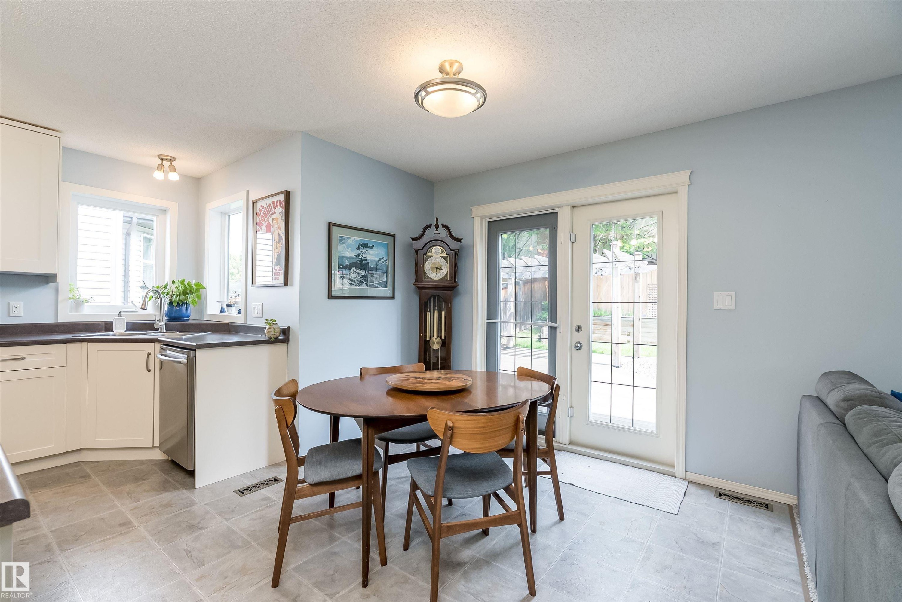 Carpeted room featuring a ceiling fan with integrated lighting, a window with a roller shade, and light-colored walls - 59 Rue Monette, Beaumont, AB
