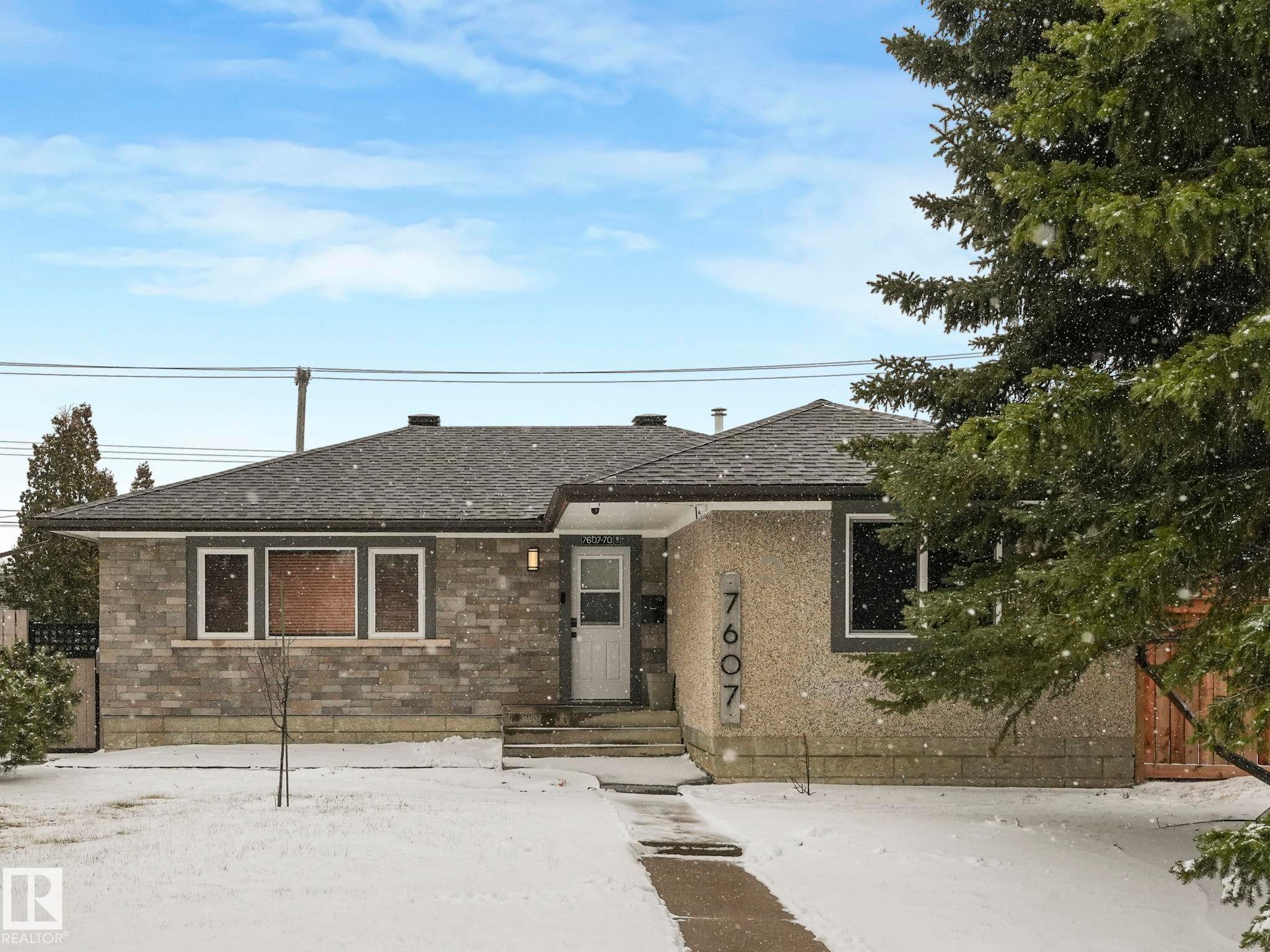 Exterior featuring a grey shingle roof, stone veneer siding, and a stucco finish - 7607 70 Avenue, Edmonton, AB - Outdoor