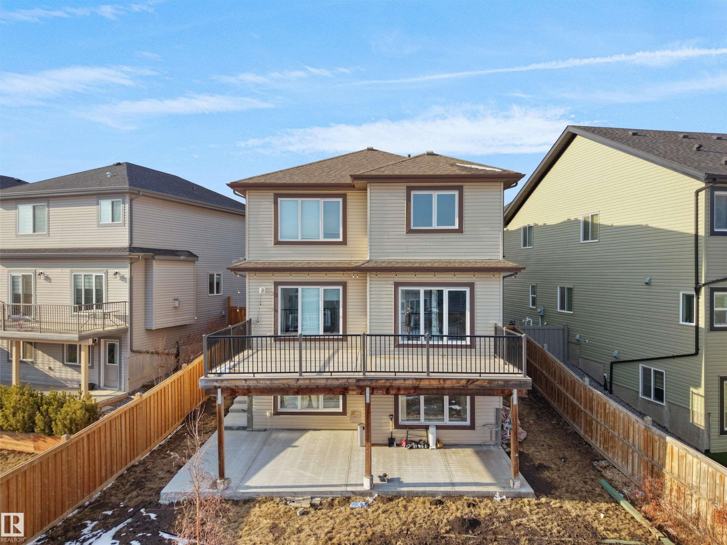 The property features a two-story exterior with light-colored siding and a brown roof - 4231 Charles Close, Edmonton, AB - Outdoor With Deck Patio Veranda