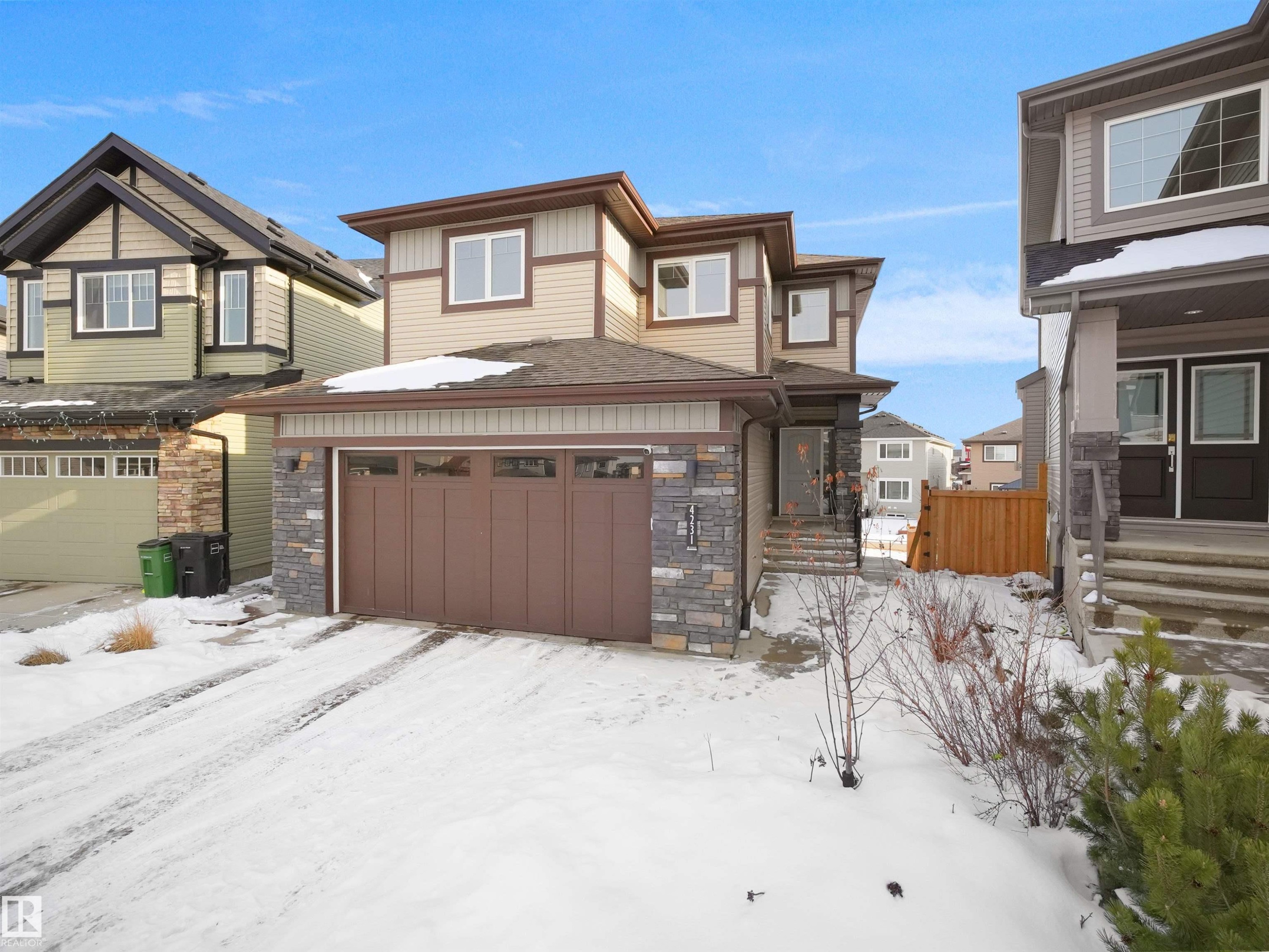 The property features a two-story exterior with light-colored siding and stone accents - 4231 Charles Close, Edmonton, AB - Outdoor