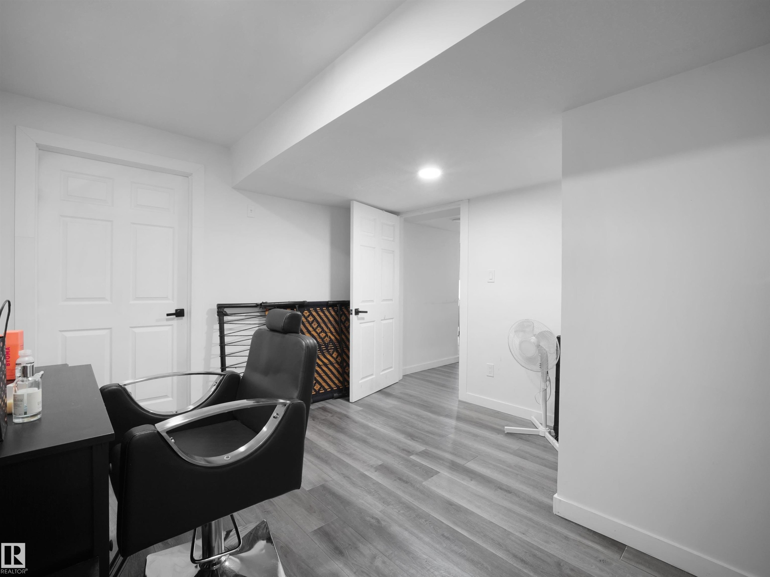 This room features light-colored walls, recessed lighting, and a door with a black handle - 4231 Charles Close, Edmonton, AB - Indoor Photo Showing Office