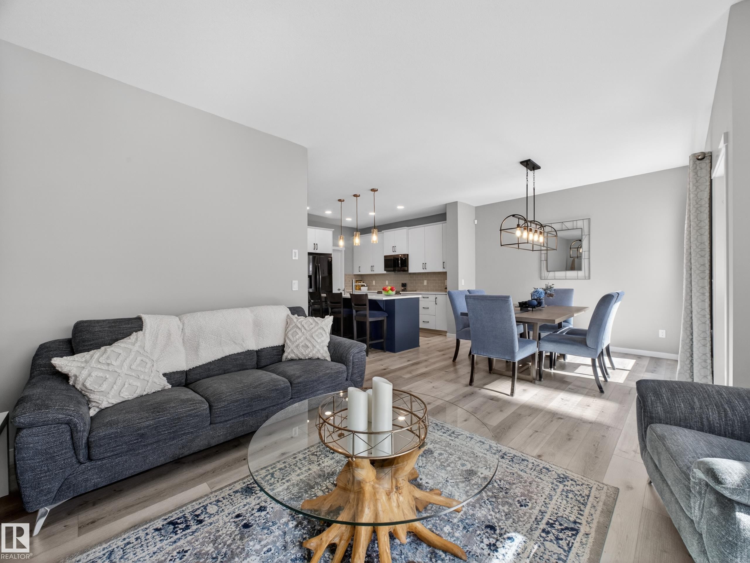 Spacious open-concept living area featuring light wood-finish flooring - 323 Balsam Link, Leduc, AB - Indoor Photo Showing Living Room